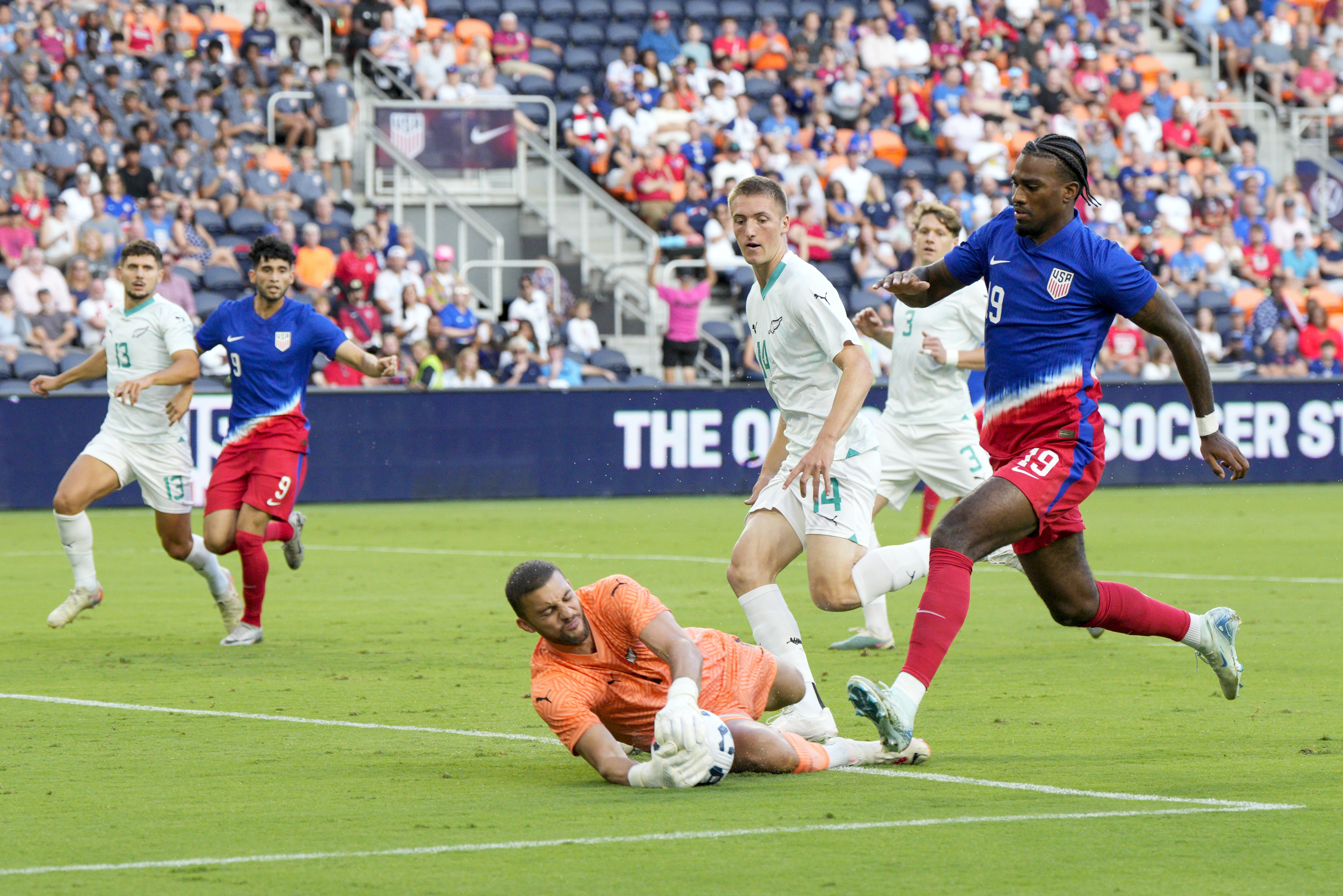 New Zealand goalkeeper Max Crocombe (1) makes a save against United States forward Haji Wright (19) during the first half of a friendly soccer match, Tuesday, Sept. 10, 2024, in Cincinnati.