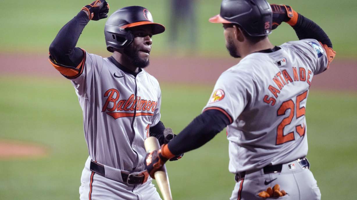 Baltimore Orioles' Cedric Mullins, left, is congratulated by Anthony Santander (25) after his solo home run in the first inning of a baseball game against the Boston Red Sox at Fenway Park, Tuesday, Sept. 10, 2024, in Boston.