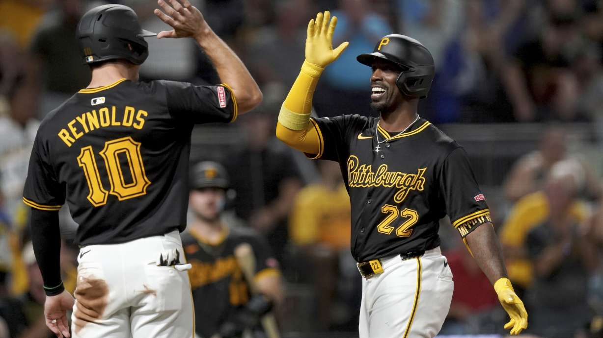 Pittsburgh Pirates' Andrew McCutchen, right, is greeted by Bryan Reynolds, left, after hitting a three-run home run during the fifth inning of a baseball game against the Miami Marlins, Tuesday, Sept. 10, 2024, in Pittsburgh.