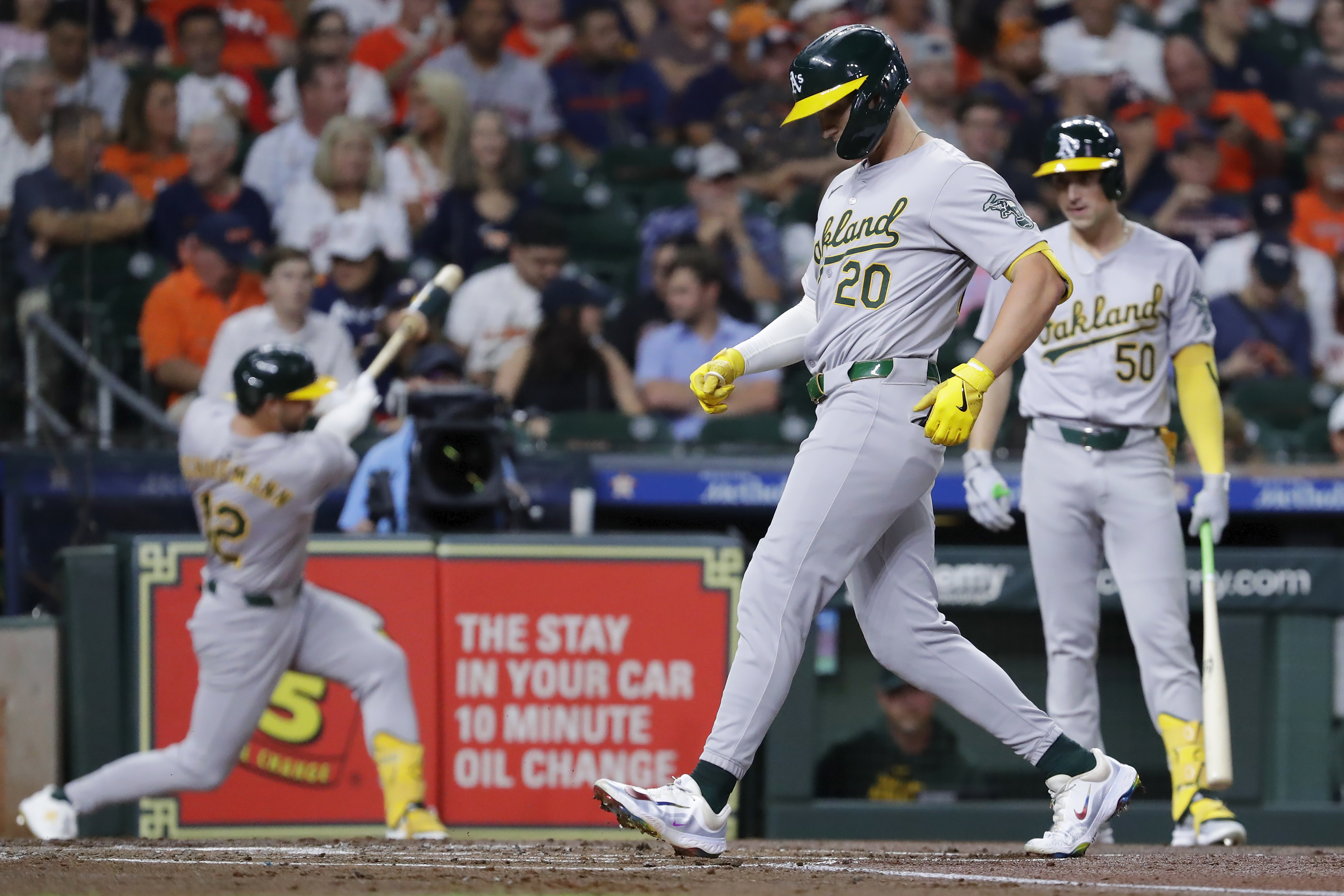 Oakland Athletics' Ryan Noda (20) touches the plate after his solo home run as Max Schuemann, left, and Armando Alvarez (50) wait on deck during the second inning of a baseball game against the Houston Astros Tuesday, Sept. 10, 2024, in Houston.
