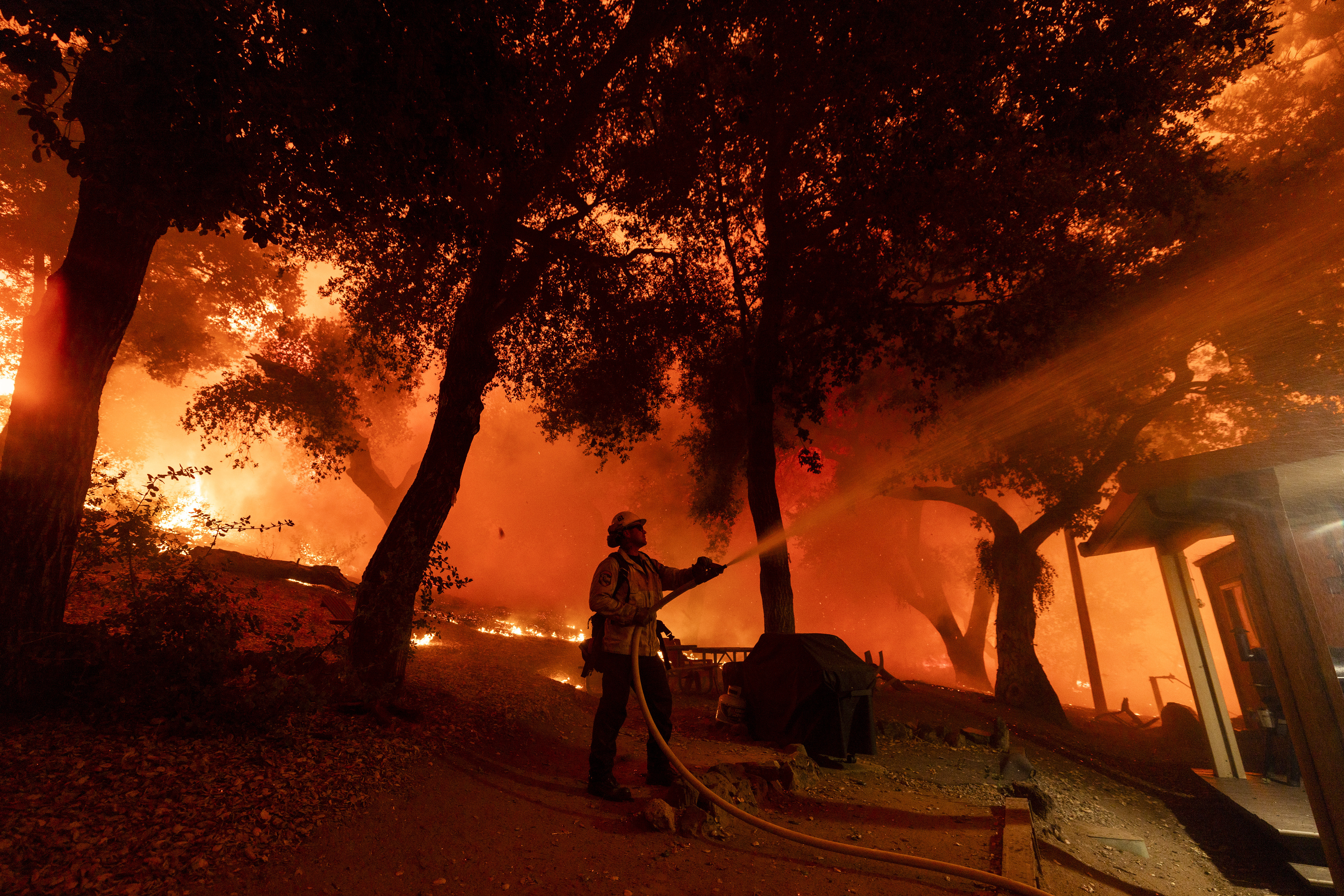 A firefighter battles the Airport Fire, Tuesday in El Cariso, an unincorporated community in Riverside County, Calif. Firefighters battled three major wildfires in Los Angeles that erupted amid a blistering heat wave.