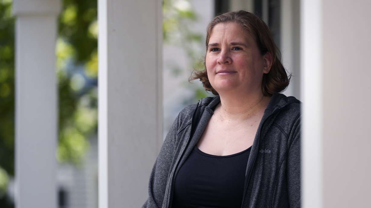 Rebecca Wood stands for a portrait outside her home, Aug. 30, in Maynard, Mass. Wood noticed a "program fee" required each time she loaded money onto her daughter's school lunch account.