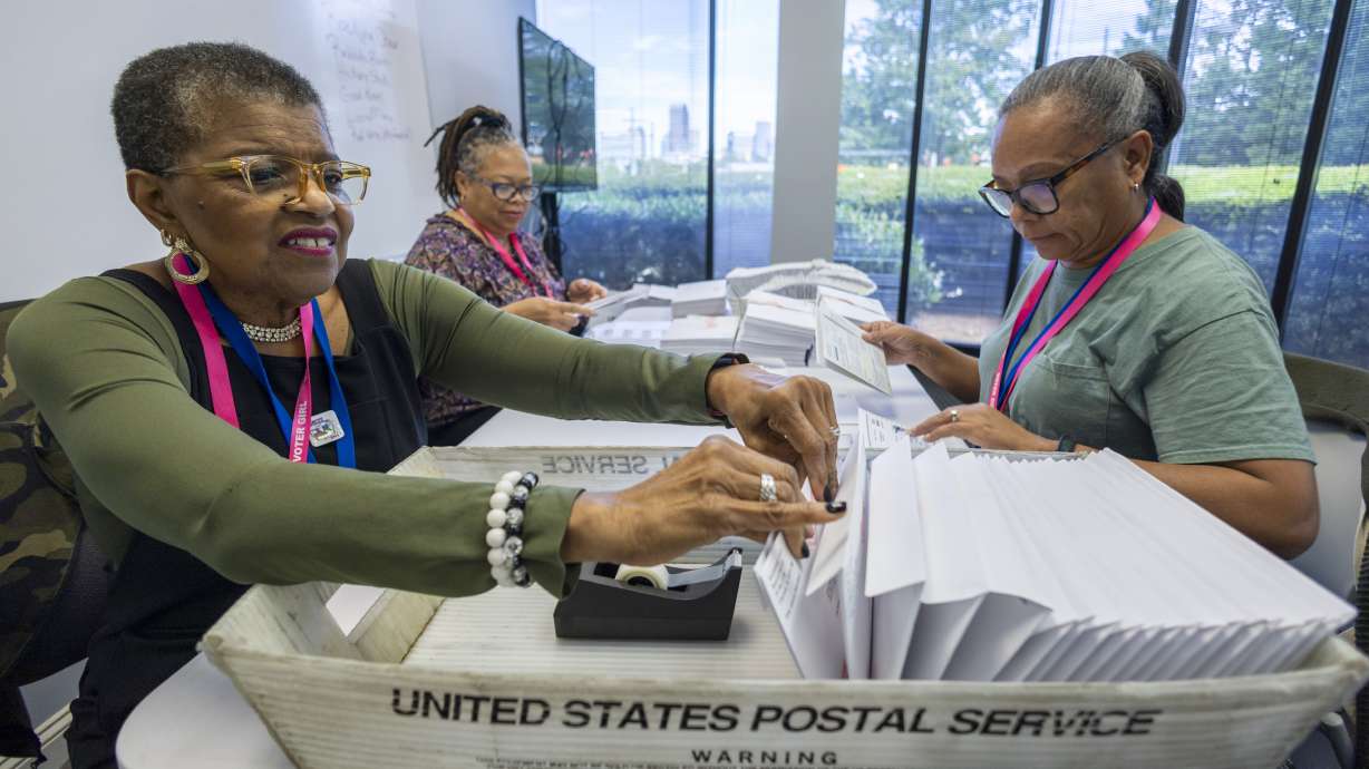 From left, Carol Hamilton, Cristo Carter and Cynthia Huntley prepare ballots to be mailed in Charlotte, N.C., Sept. 5. Election officials across the U.S. are warning that problems with the nation's mail delivery system threaten to disenfranchise voters in the upcoming election.