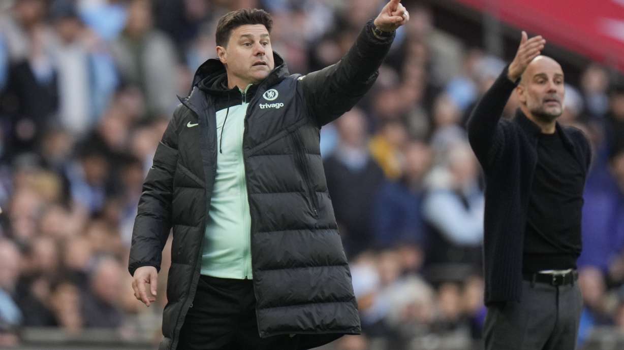 FILE - Chelsea's head coach Mauricio Pochettino, left, and Manchester City's head coach Pep Guardiola gesture during the English FA Cup semifinal soccer match between Manchester City and Chelsea at Wembley stadium in London, Saturday, April 20, 2024.