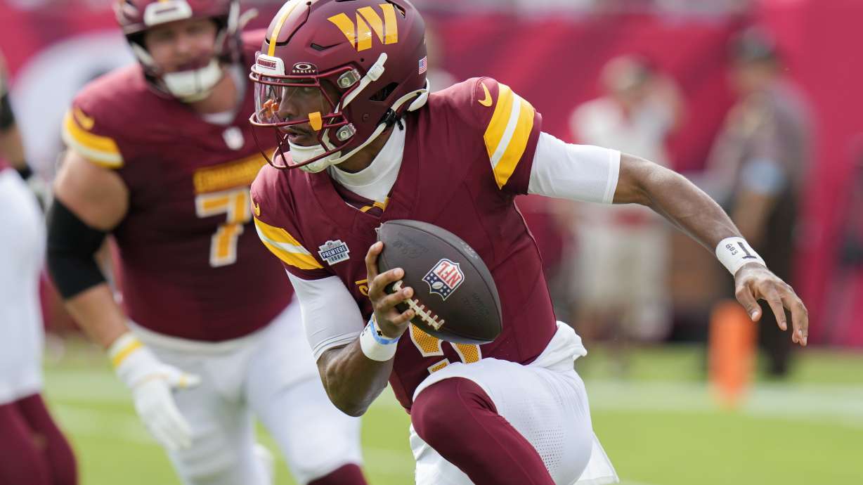 Washington Commanders quarterback Jayden Daniels scrambles against the Tampa Bay Buccaneers during the first half of an NFL football game Sunday, Sept. 8, 2024, in Tampa, Fla.