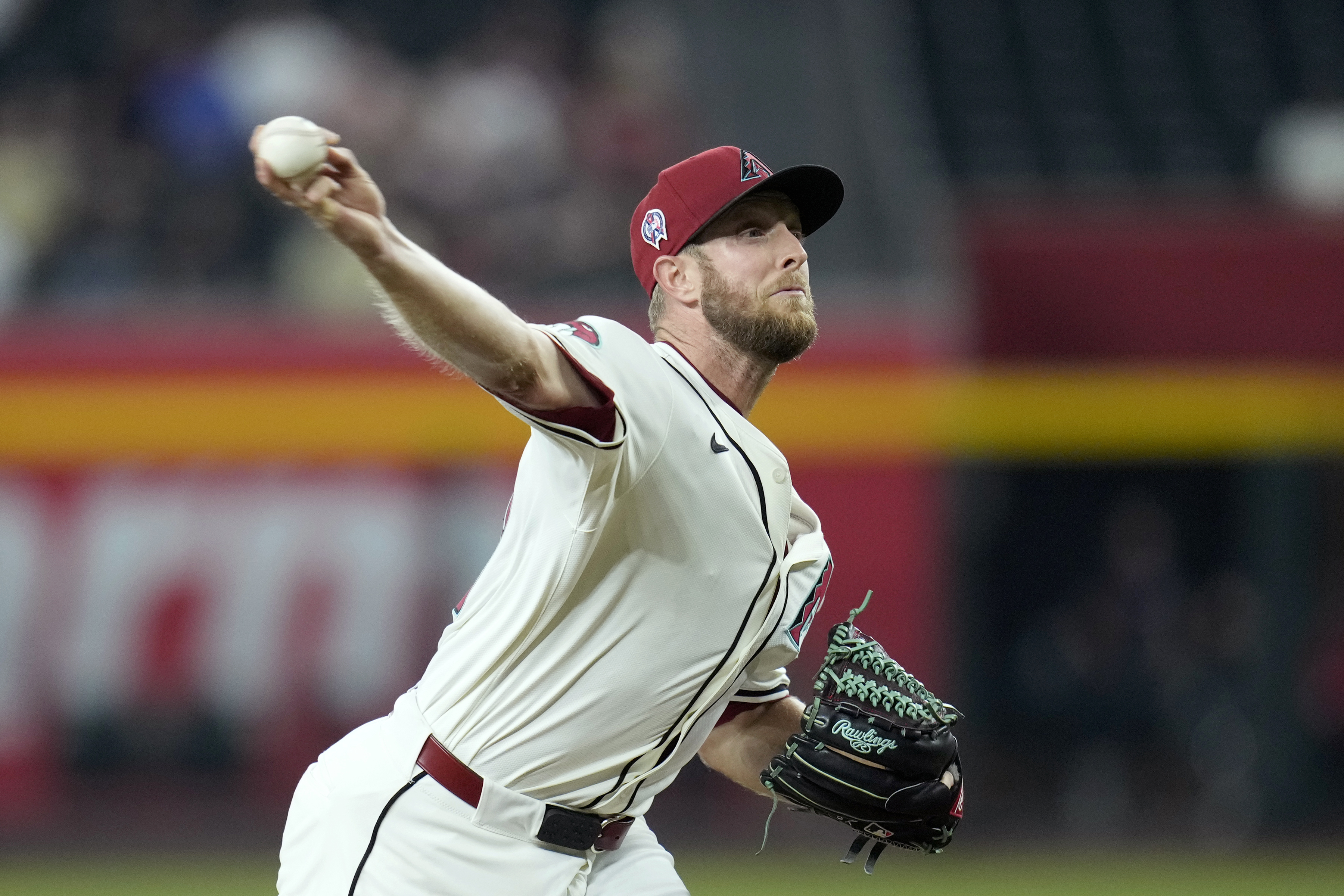 Arizona Diamondbacks pitcher Merrill Kelly throws against the Texas Rangers during the first inning of a baseball game Wednesday, Sept. 11, 2024, in Phoenix.