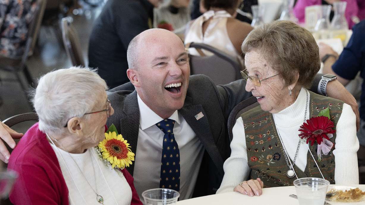 Gov. Spencer Cox laughs with centenarians Jane Rohde and Vilate Jones at the Utah Centenarian Celebration at the Viridian Event Center in West Jordan on Wednesday..