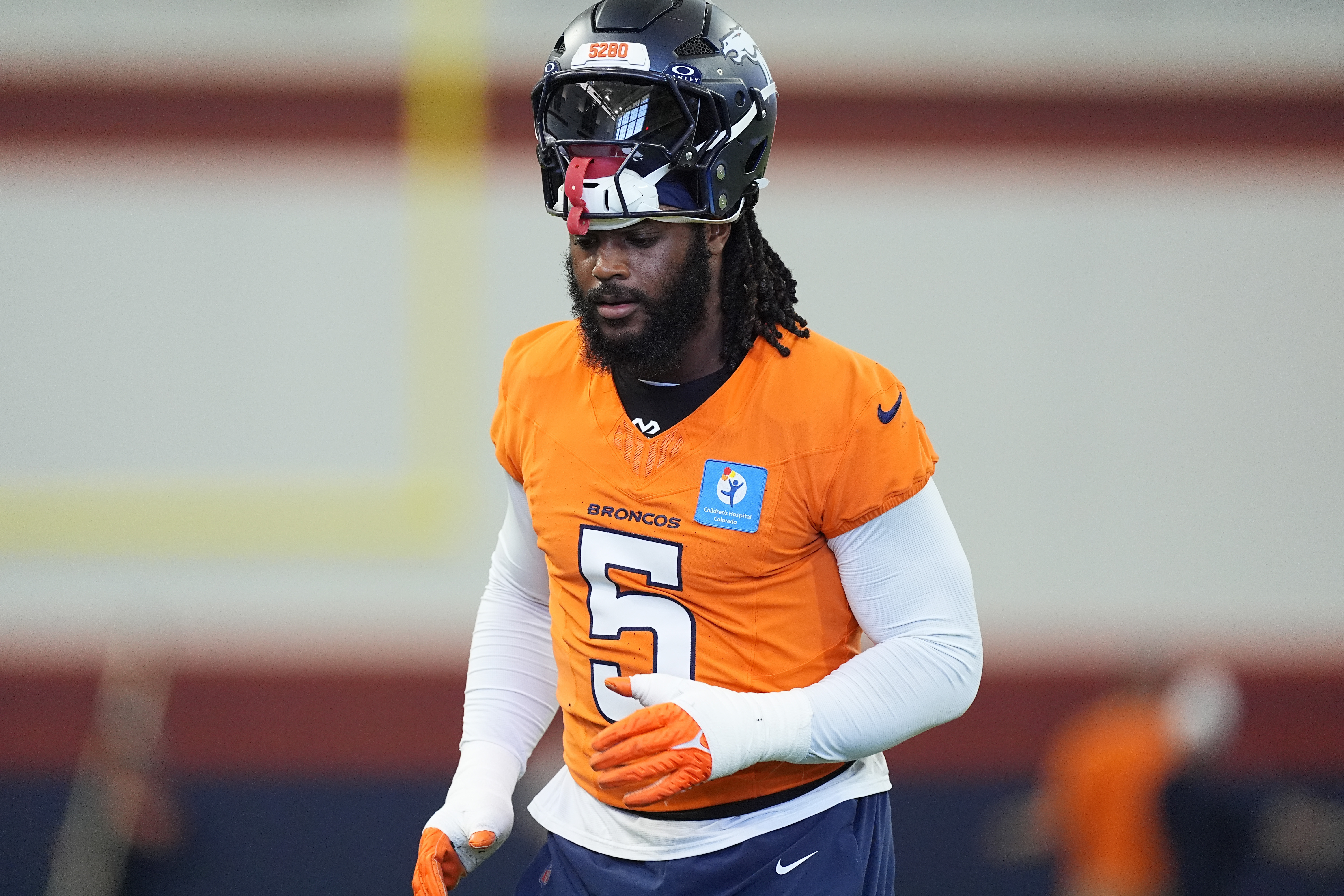 Denver Broncos linebacker Baron Browning heads over to take part in a drill during an NFL football practice Friday, Sept. 6, 2024, at the team's headquarters in Centennial, Colo.