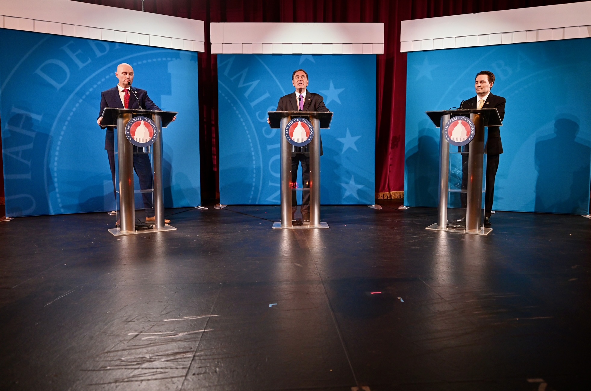 Utah Gov. Spencer Cox, Democratic state Rep. Brian King and Libertarian attorney Robert Latham take the stage at the Salt Lake City Community College South campus on Wednesday.