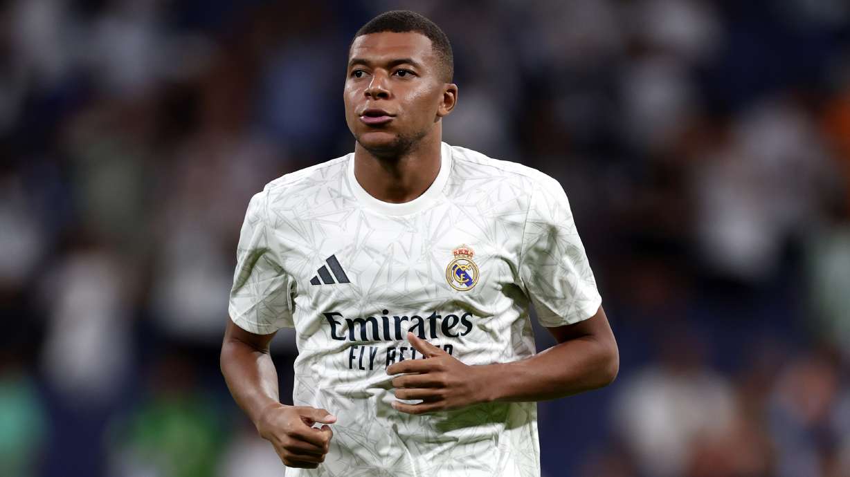 Real Madrid's Kylian Mbappe warms up for the Spanish La Liga soccer match between Real Madrid and Betis at the Santiago Bernabeu stadium in Madrid, Spain, Sunday, Sept. 1, 2024.