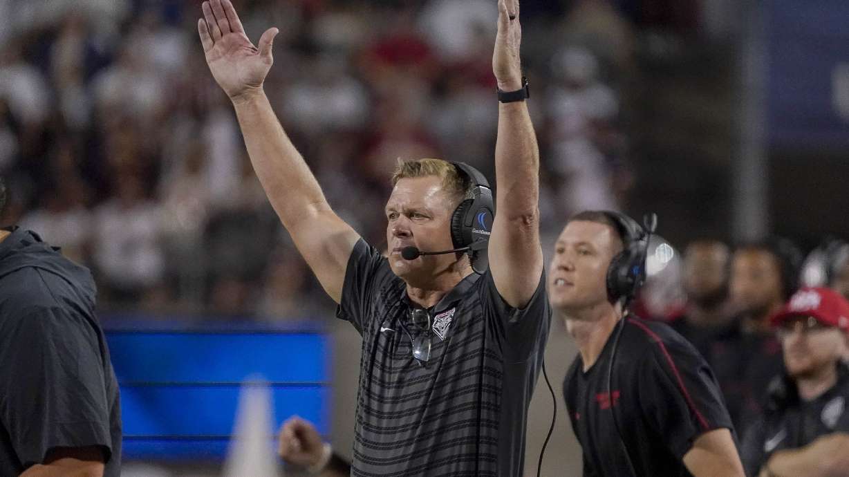 New Mexico head coach Bronco Mendenhall gestures after his team scores against Arizona during the first half of an NCAA college football game Saturday, Aug. 31, 2024, in Tucson, Ariz.