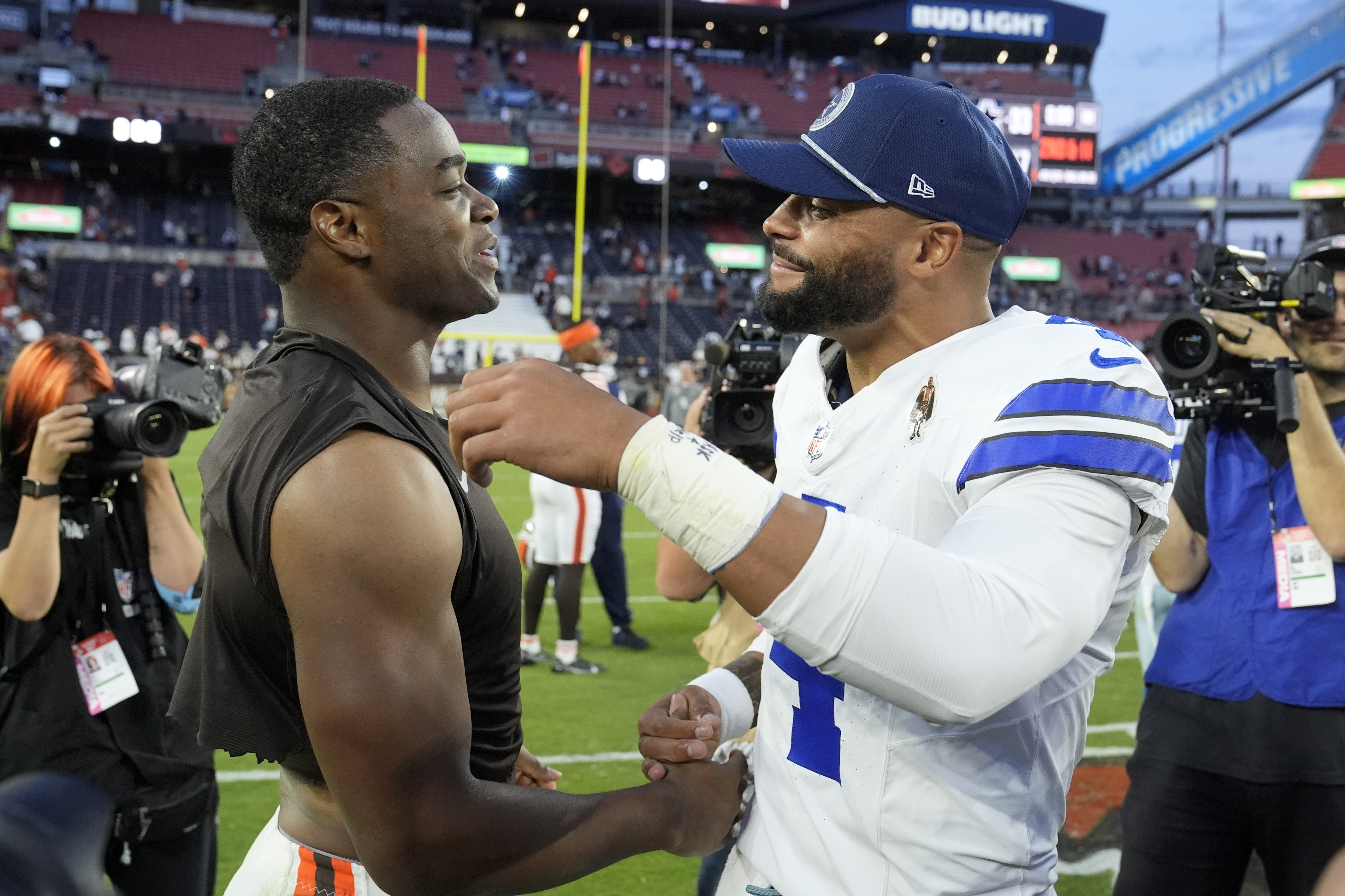 Cleveland Browns' Amari Cooper, left, and Dallas Cowboys' Dak Prescott, right, greet each other after their team's NFL football game in Cleveland, Sunday, Sept. 8, 2024.