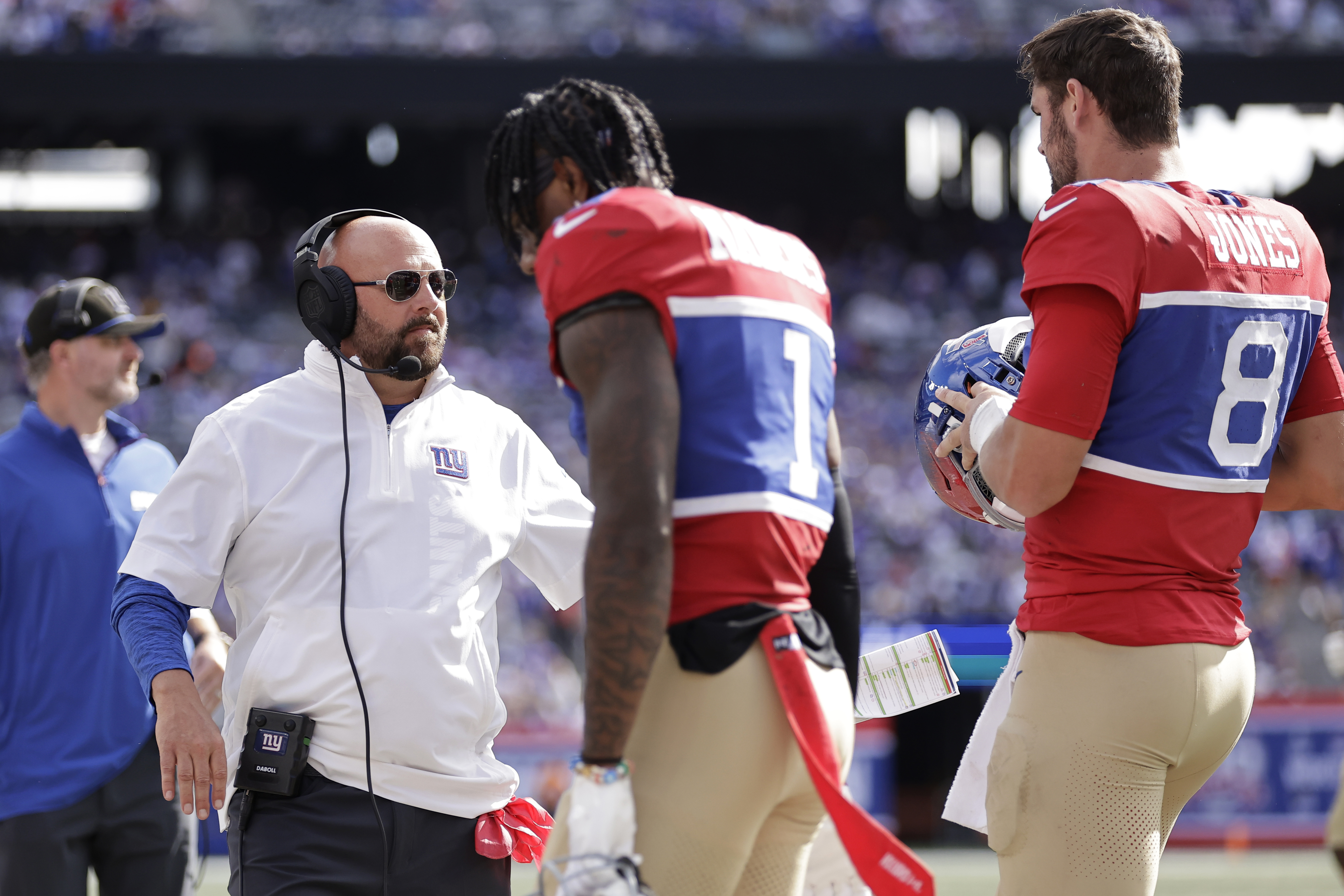 New York Giants head coach Brian Daboll stands on the sideline as wide receiver Malik Nabers (1) and quarterback Daniel Jones (8) walk off the field during the second half of an NFL football game against the Minnesota Vikings, Sunday, Sept. 8, 2024, in East Rutherford, N.J.