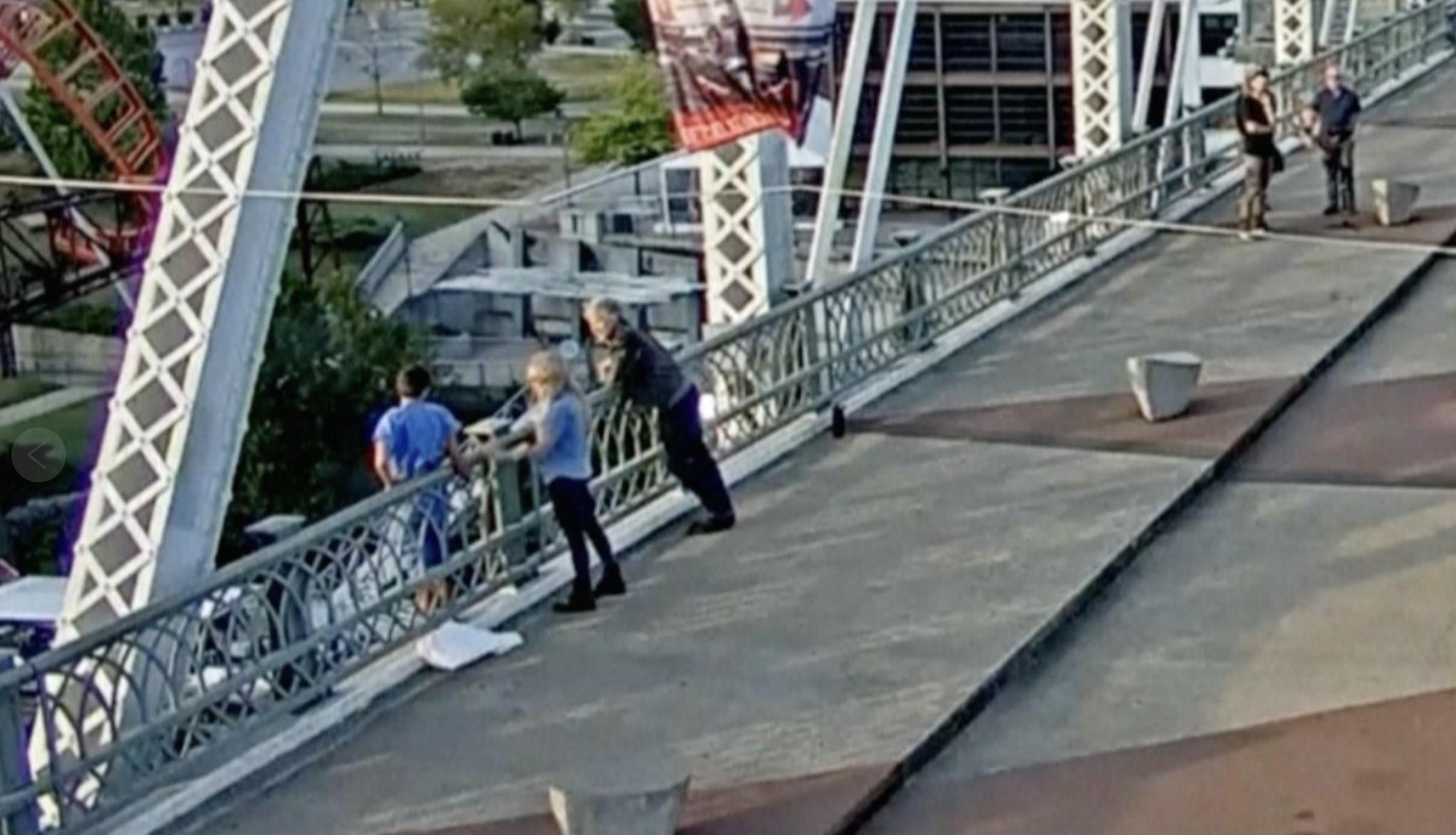 Rock & Roll Hall of Famer Jon Bon Jovi and a video production assistant persuaded a woman standing on the ledge of a pedestrian bridge in Nashville to come back over the railing to safety Tuesday.