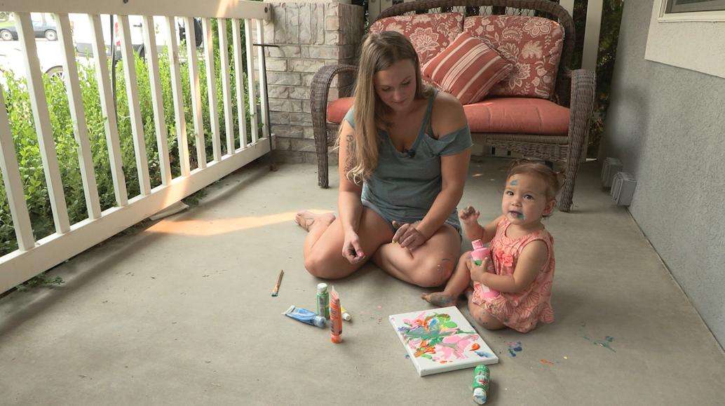 Fifteen-month-old Kinsley Muir paints with her mother, Jennifer. Kinsley created two paintings that have won first place at the Utah State Fair.
