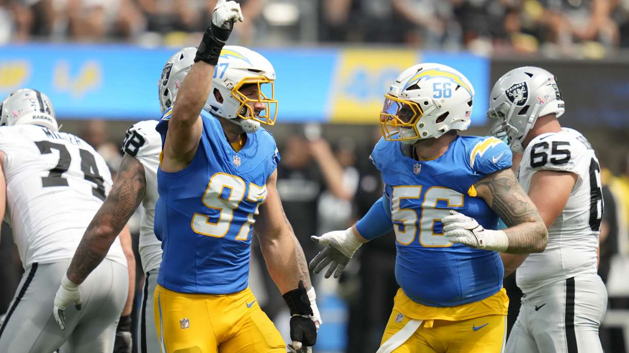 Los Angeles Chargers linebacker Joey Bosa (97) is congratulated by defensive end Morgan Fox (56) after sacking Las Vegas Raiders quarterback Gardner Minshew II during the first half of an NFL football game, Sunday, Sept. 8, 2024, in Inglewood, Calif.