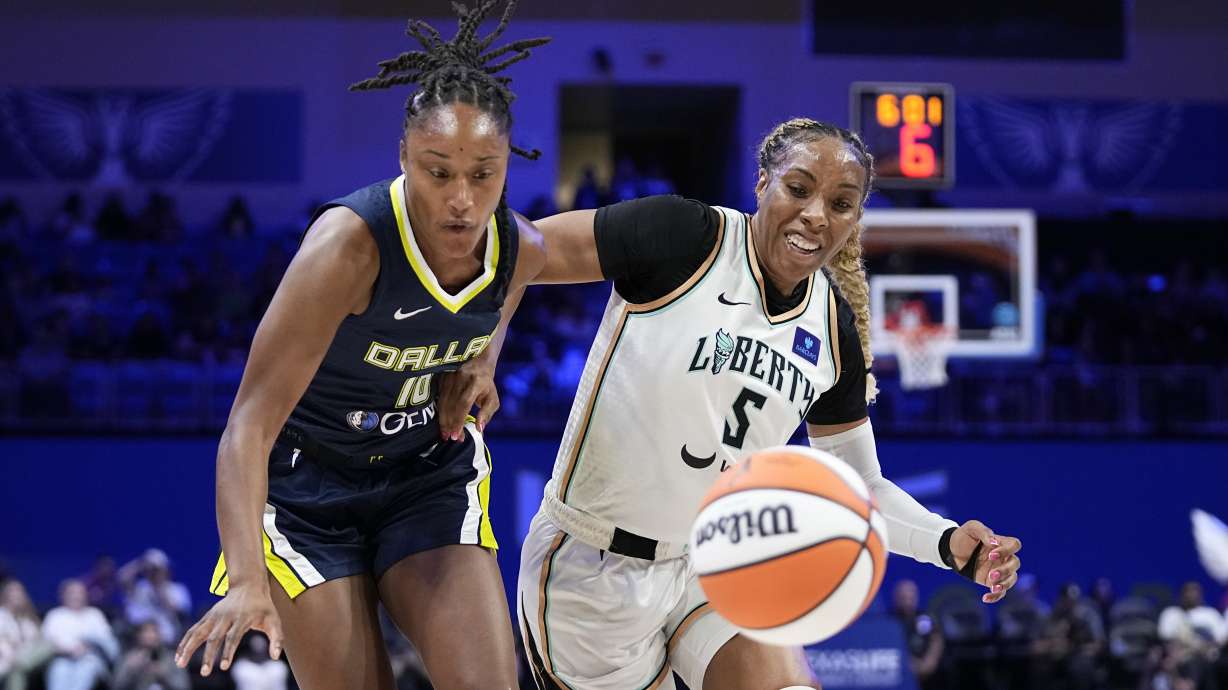 Dallas Wings guard Jaelyn Brown, left, and New York Liberty forward Kayla Thornton (5) chase the ball in the first half of a WNBA basketball game, Thursday, Sept. 12, 2024, in Arlington, Texas.