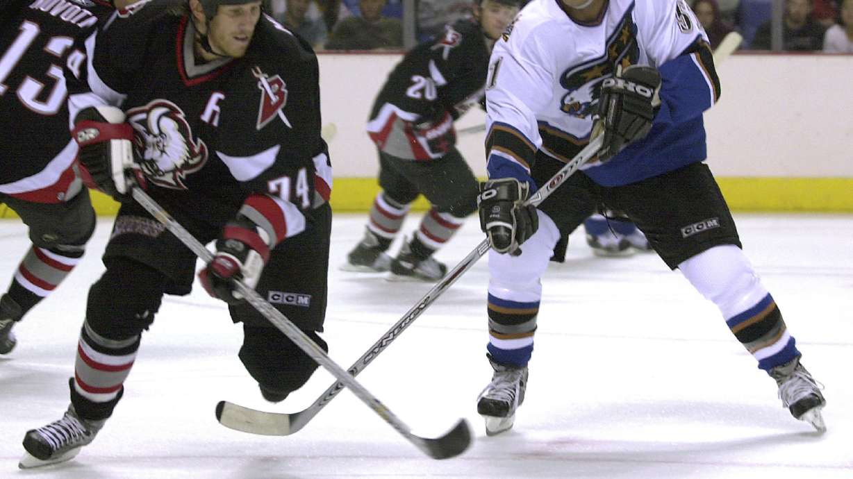 FILE - Buffalo Sabres defenseman Jay McKee (74) tries to avoid a stick-check by Washington Capitals right-winger Stephen Peat (51) as he skates up ice during the first period at the HSBC Arena in Buffalo, N.Y., Sept. 17, 2005.