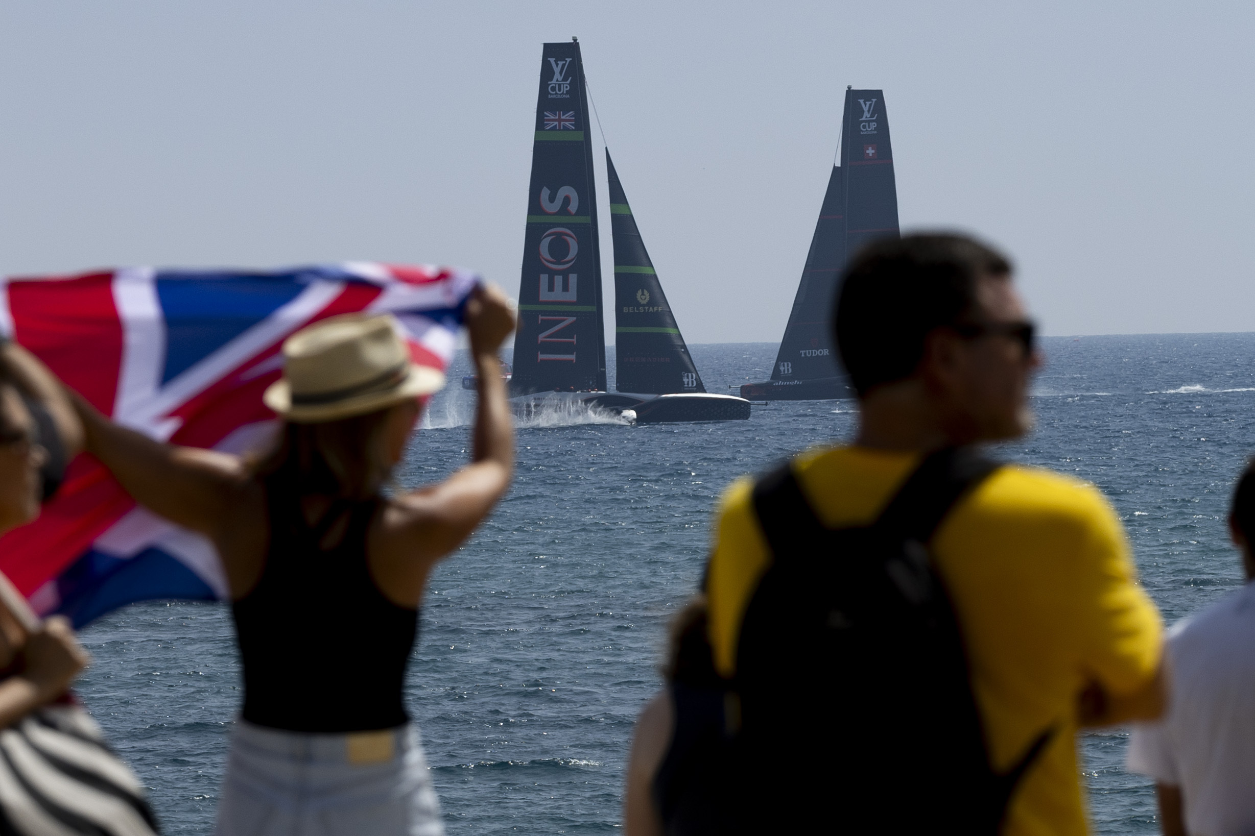 Spectators watch the race between Ineos Britannia's AC75 and Alinghi Red Bull Racing's AC75 boats during the America's Cup Preliminary Regatta ahead of the 37th America's Cup sailing race off the coast of Barcelona, Spain, Saturday, Aug. 24, 2024. The world's oldest international sports trophy, best yachtsmen and cutting-edge design and technology will come together in Barcelona when the 37th edition of the America's Cup starts on Thursday.