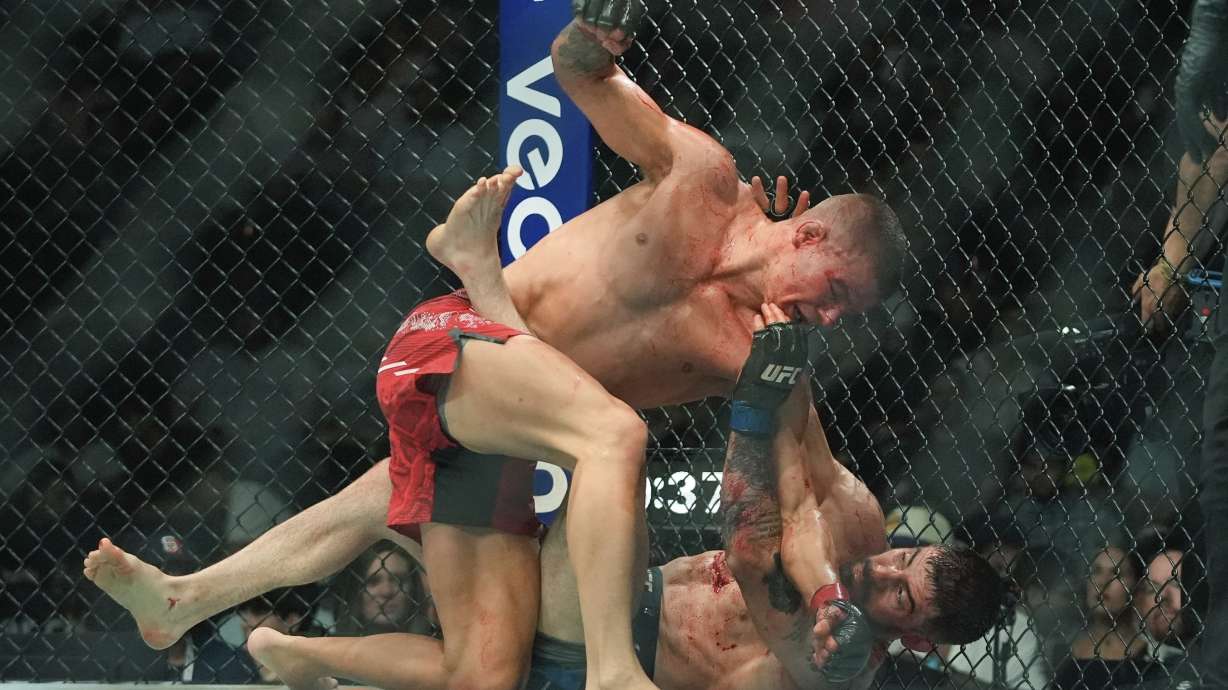 FILE - Grant Dawson, top, works against Joe Solecki during the second round of a lightweight bout at the UFC 302 mixed martial arts event, June 1, 2024, in Newark, N.J.