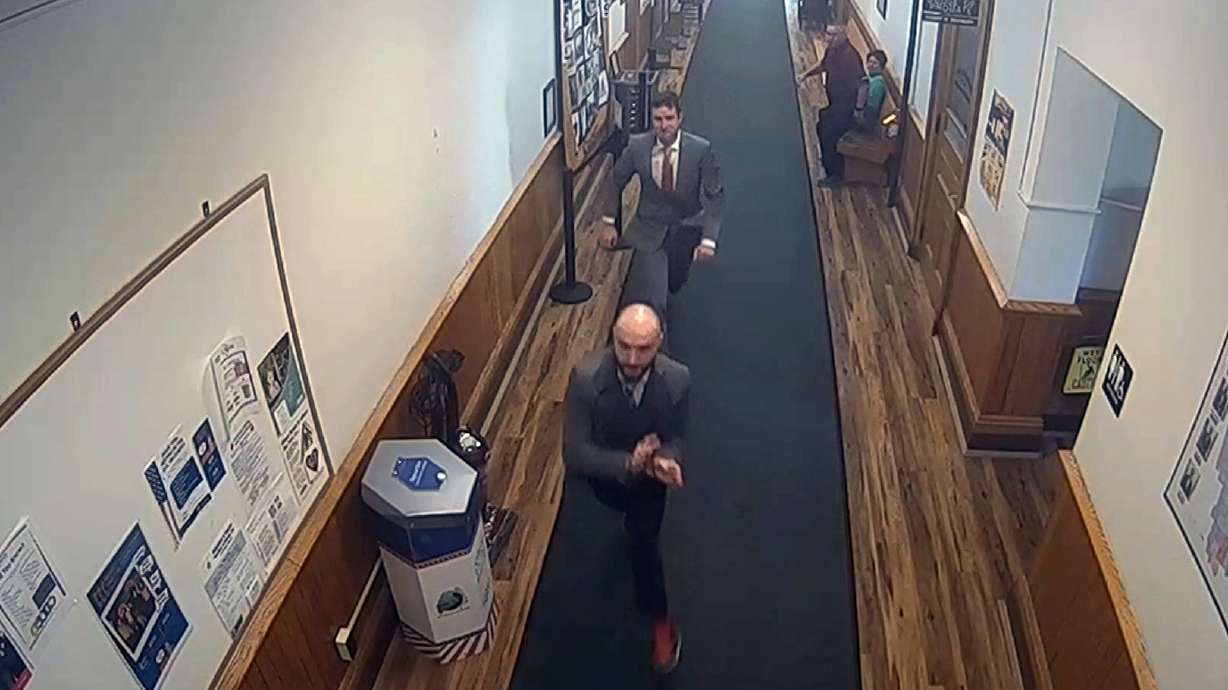 Nicholas Carter, 31, attempts to flee a courthouse while in handcuffs Wednesday in Skowhegan, Maine, after a jury convicted him of aggravated assault against a 14-month-old child. The escape was quickly foiled by two jurors and a detective.