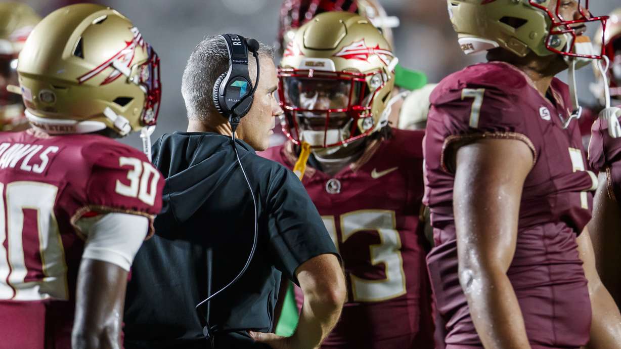Florida State head coach Mike Norvell, center left, is surrounded by his team in the final seconds of an NCAA college football game against Boston College, Monday, Sept. 2, 2024, in Tallahassee, Fla.