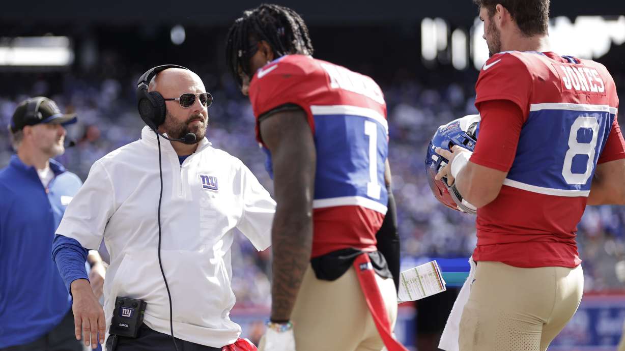 New York Giants head coach Brian Daboll stands on the sideline as wide receiver Malik Nabers (1) and quarterback Daniel Jones (8) walk off the field during the second half of an NFL football game against the Minnesota Vikings, Sunday, Sept. 8, 2024, in East Rutherford, N.J.