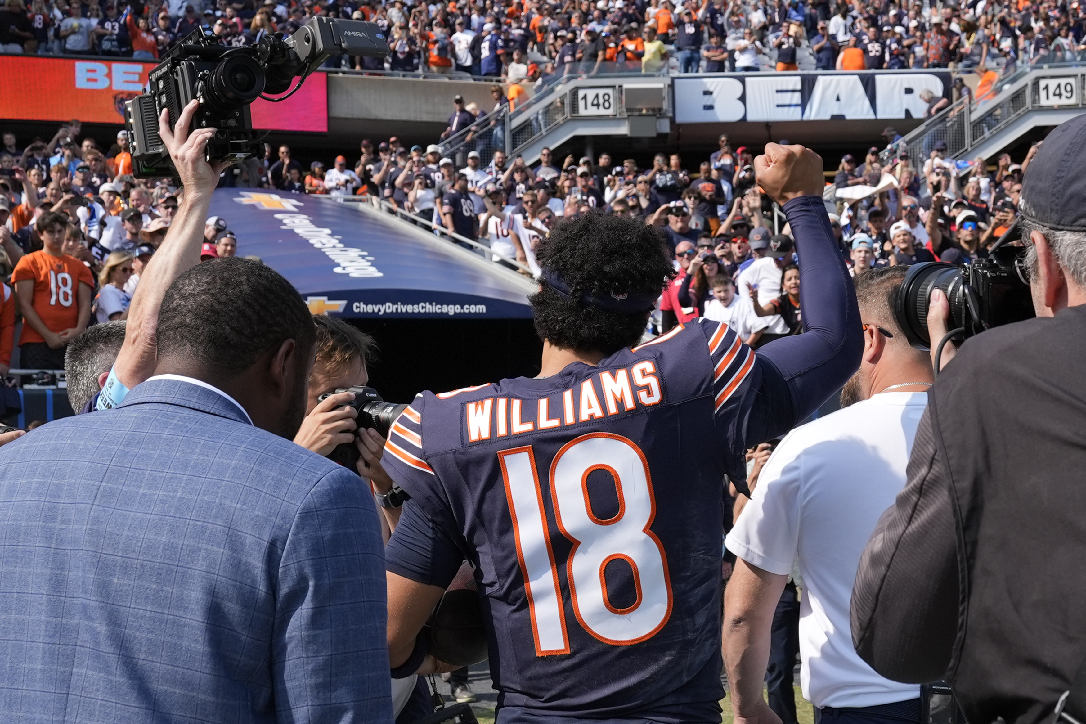 Chicago Bears quarterback Caleb Williams walks off the field and salutes the crowd after the team's 24-17 win over the Tennessee Titans in an NFL football game Sunday, Sept. 8, 2024, in Chicago.