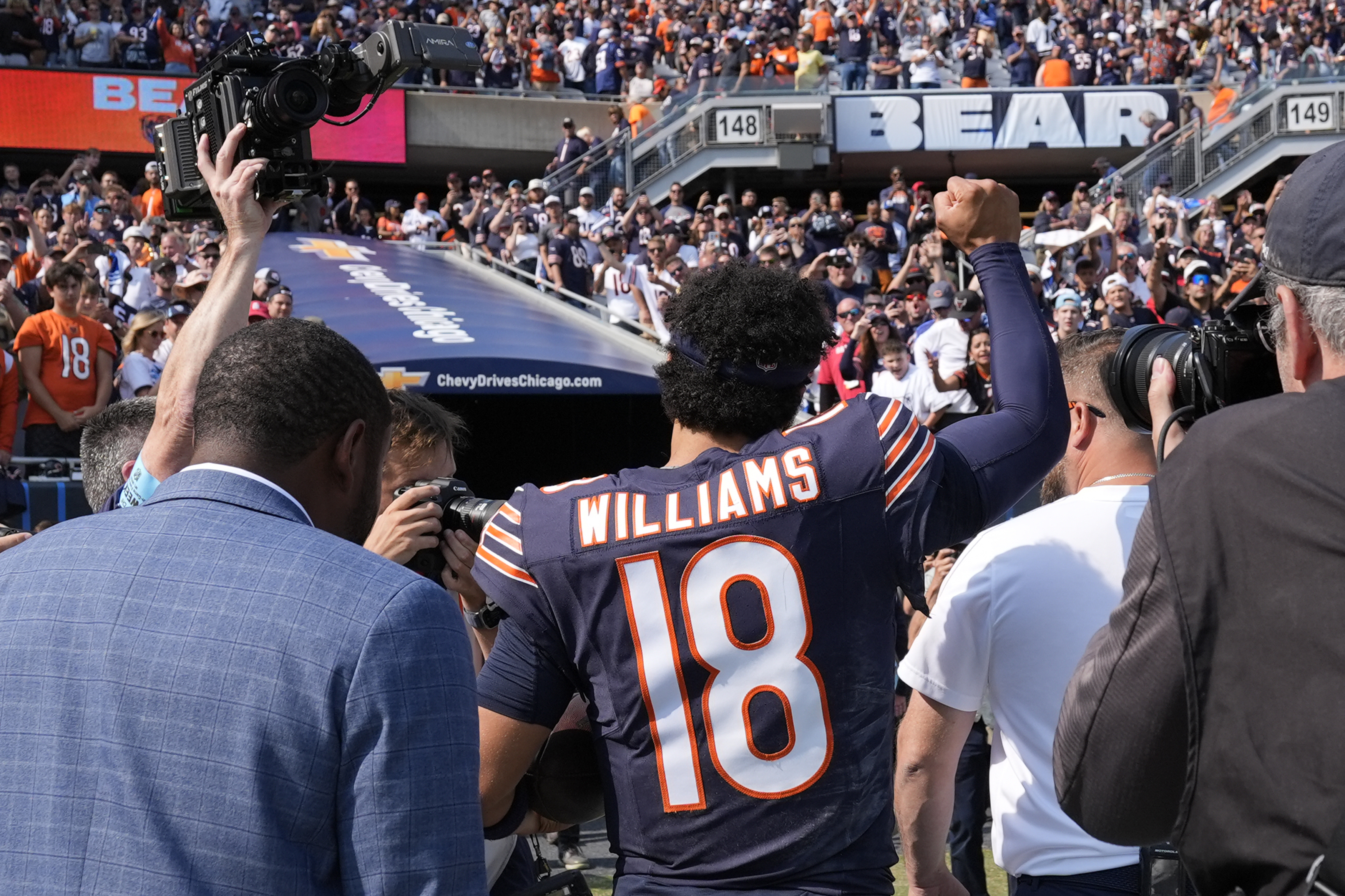 Chicago Bears quarterback Caleb Williams walks off the field and salutes the crowd after the team's 24-17 win over the Tennessee Titans in an NFL football game Sunday, Sept. 8, 2024, in Chicago. 