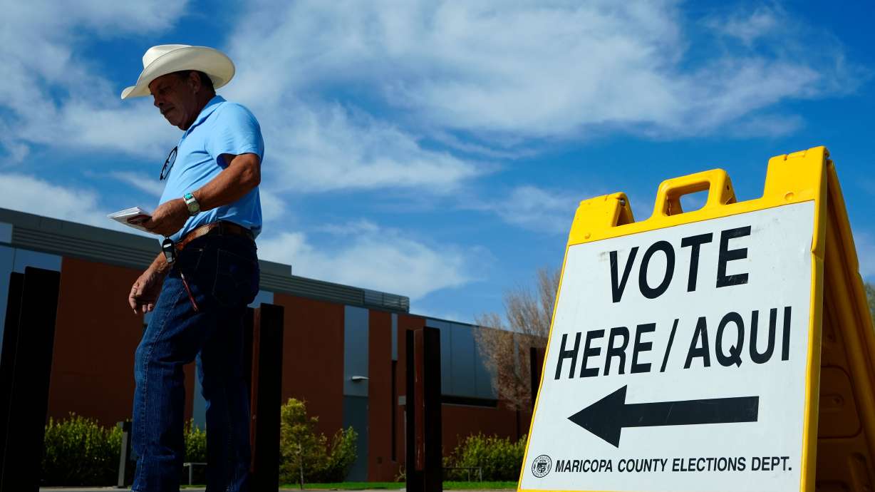 A voter walks to a voting precinct prior to casting his ballot in the state's primary election, July 30 in El Mirage, Ariz. The issues voters are most worried about this election cycle are felt especially deep in Utah's swing-state neighbors, Nevada and Arizona.