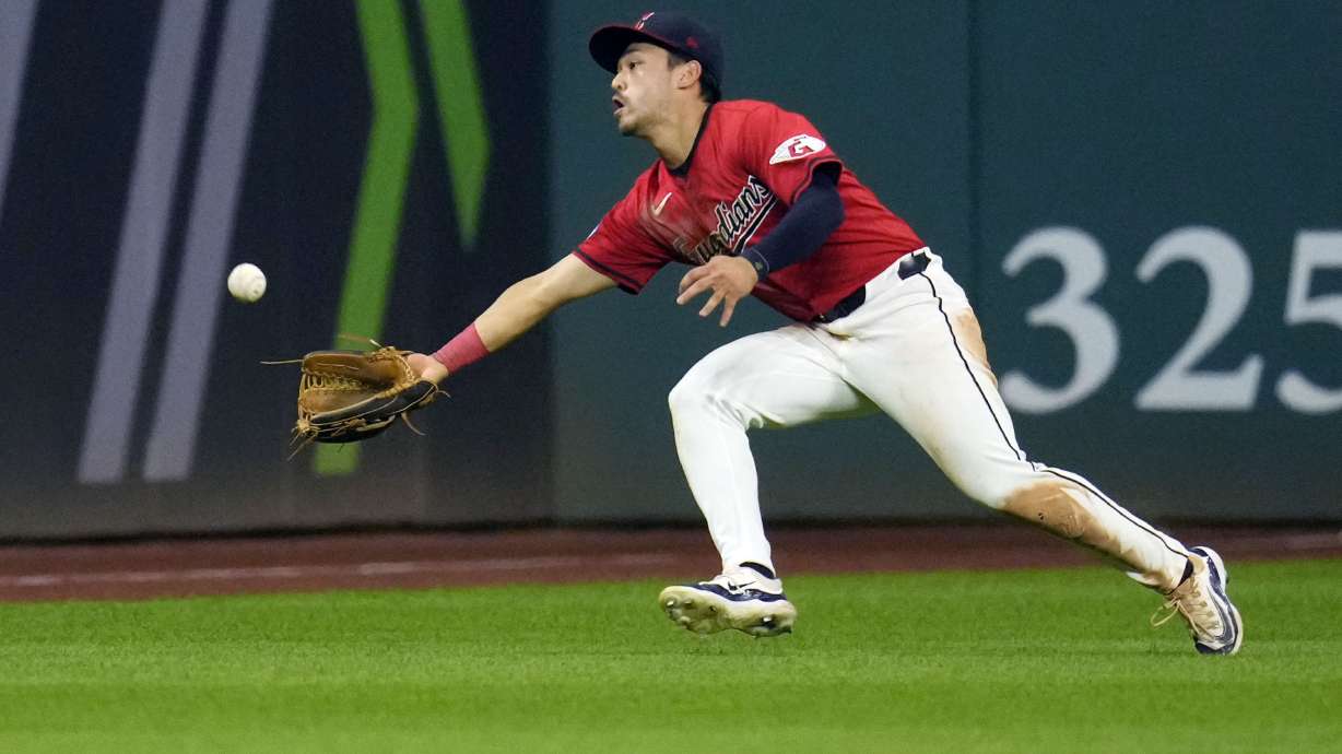 Cleveland Guardians left fielder Steven Kwan reaches for but cannot catch a ball hit for a single by Tampa Bay Rays' Ben Rortvedt in the seventh inning of a baseball game Thursday, Sept. 12, 2024, in Cleveland.