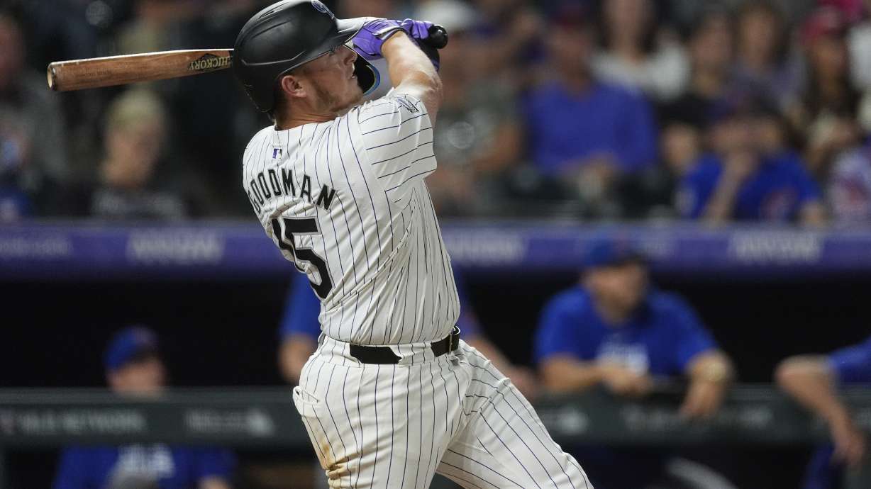 Colorado Rockies' Hunter Goodman follows the flight of his grand slam off Chicago Cubs relief pitcher Nate Pearson in the eighth inning of a baseball game, Friday, Sept. 13, 2024, in Denver.