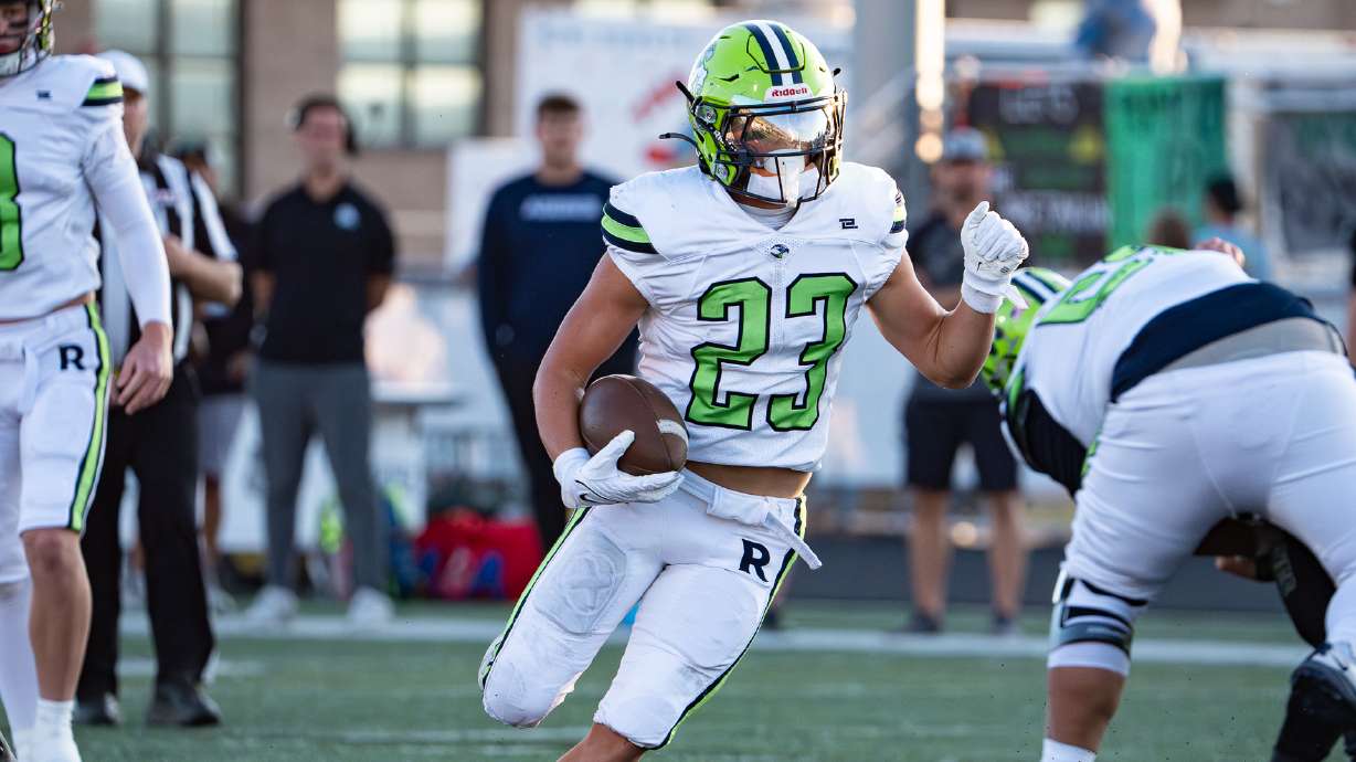 Ridgeline running back JT White finds an open lane to run through against rival Green Canyon in North Logan on Sept. 13, 2024.