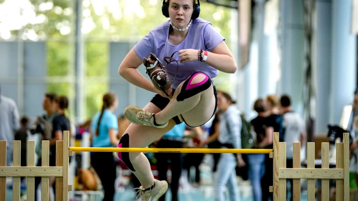 A participant clears the bar during the first German Hobby Horsing Championship in Frankfurt, Germany, Saturday, Sept. 14, 2024.