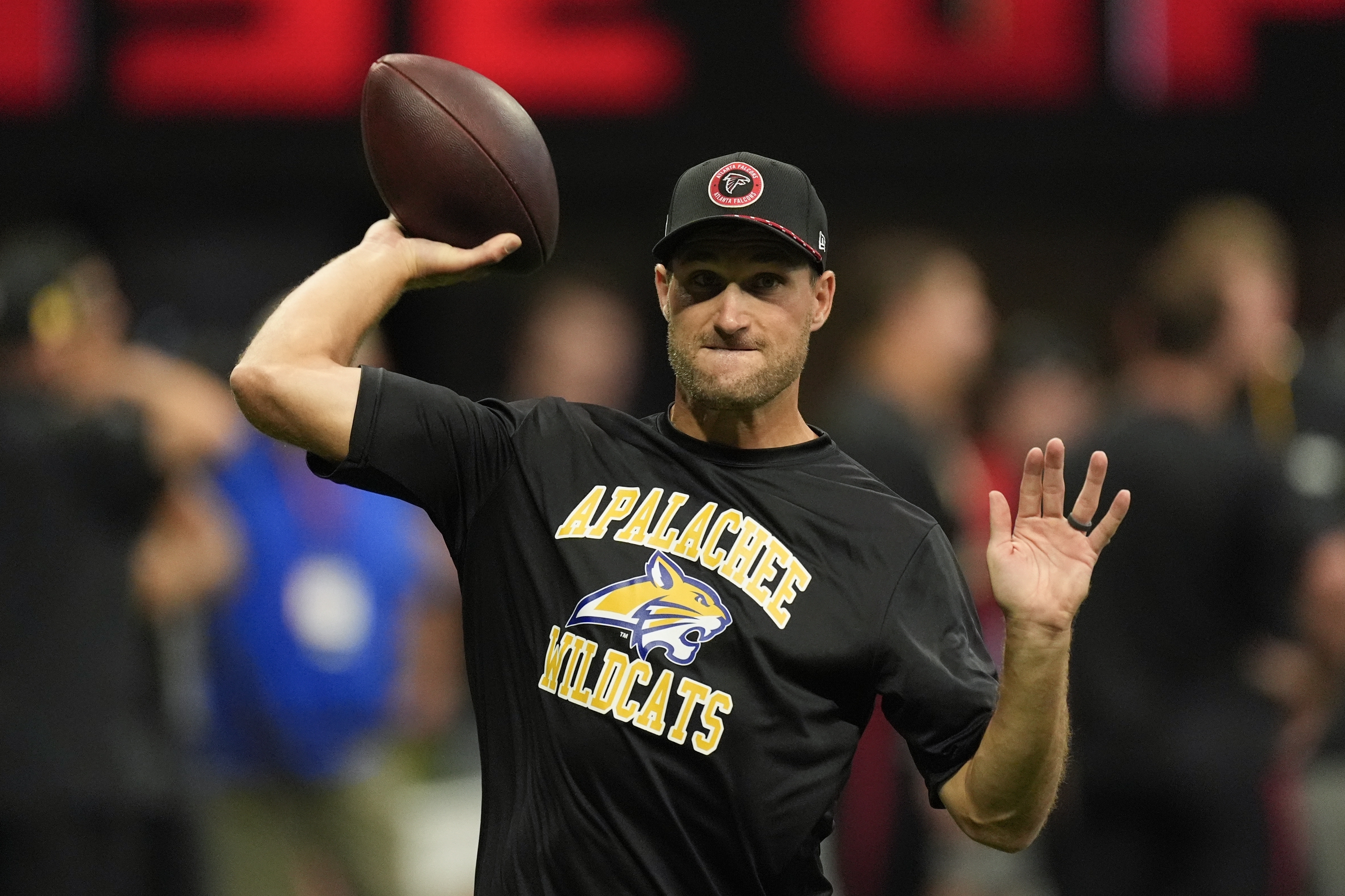 Atlanta Falcons quarterback Kirk Cousins warms up, while wearing an Apalachee High School T-shirt following a recent school shooting there, before an NFL football game against the Pittsburgh Steelers on Sunday, Sept. 8, 2024, in Atlanta.