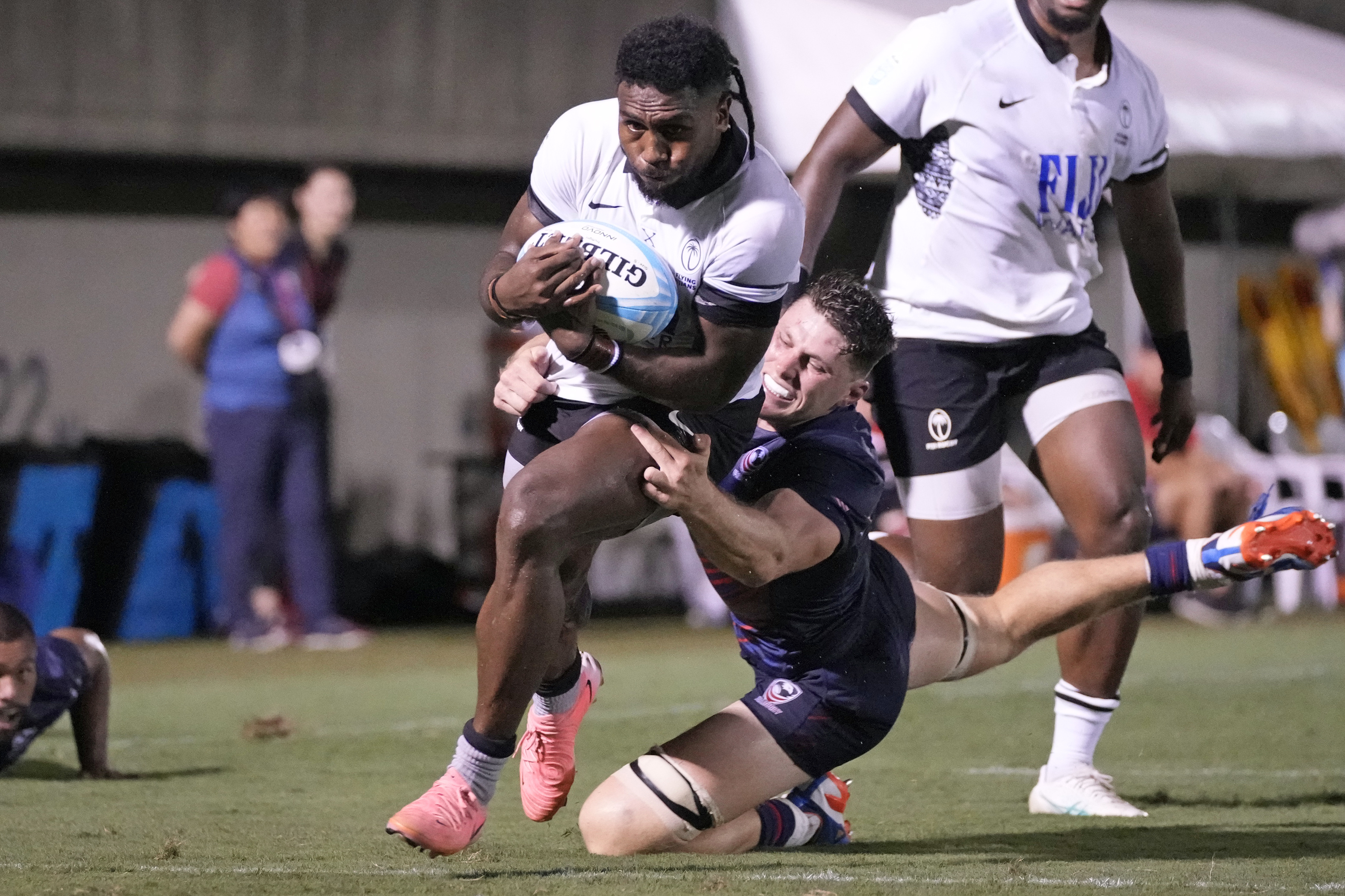 Fiji's Frank Lomani, center, scores try against Cory Daniel of the U.S, during the semifinal of the Pacific Nations Cup rugby match at Prince Chichibu Memorial Stadium in Tokyo, Saturday, Sept. 14, 2024.