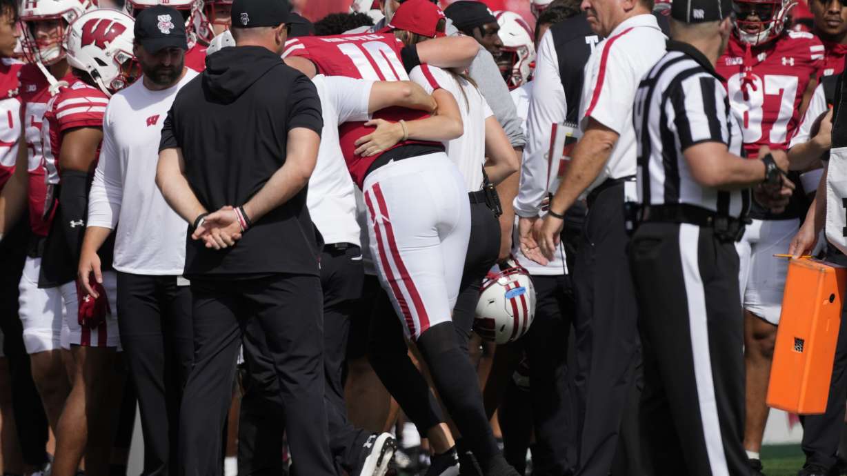 Wisconsin's Tyler Van Dyke (10) is helped off the field during the first half of an NCAA college football game against Alabama Saturday, Sept. 14, 2024, in Madison, Wis.