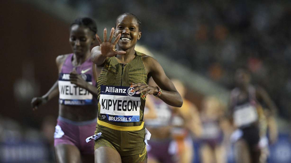 Faith Kipyegon, of Kenya, celebrates after crossing the finish line to win the women's 1500 meters during the Diamond League final 2024 athletics meet in Brussels, Saturday, Sept. 14, 2024.