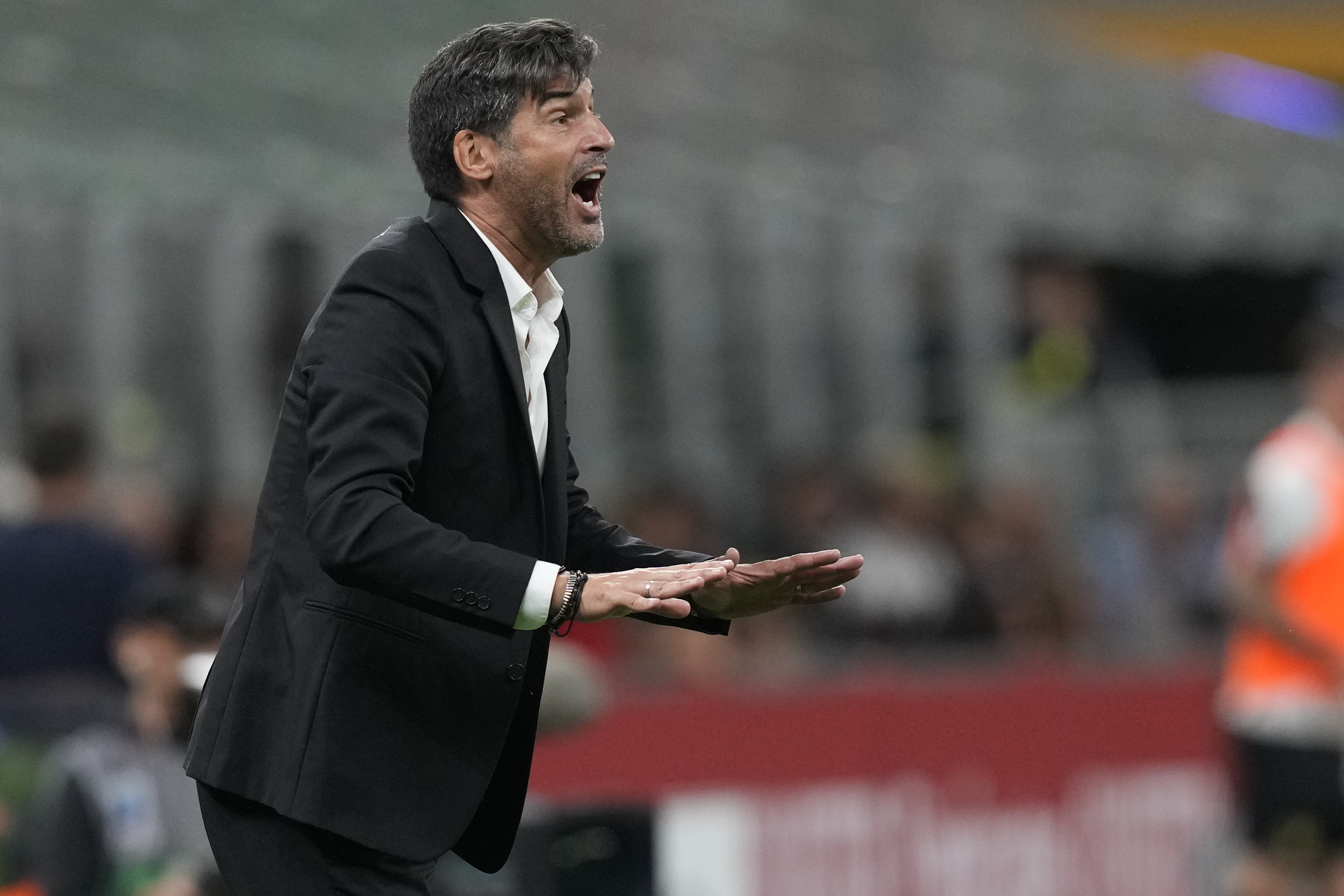 AC Milan's head coach Paulo Fonseca gives instructions during the Serie A soccer match between AC Milan and Venezia at the San Siro stadium, in Milan, Italy, Saturday, Sept. 14, 2024.