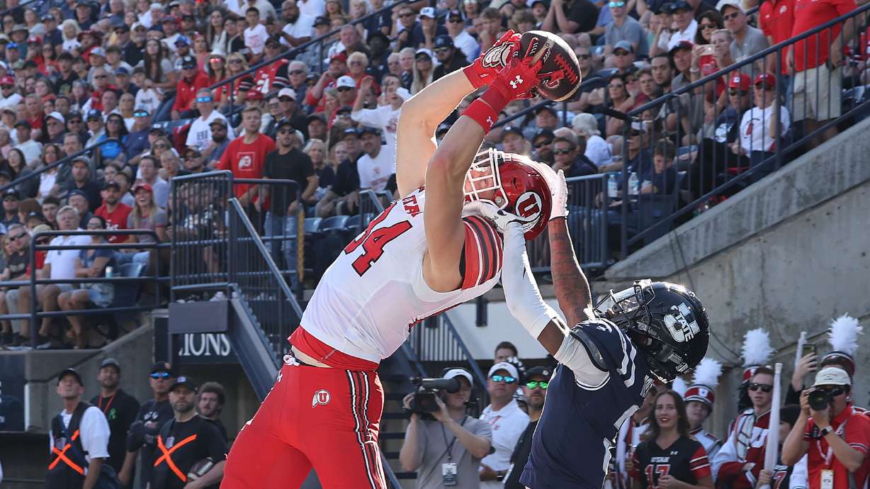 Utah Utes tight end Caleb Lohner (84) scores against Utah State Aggies cornerback JD Drew (3) in Logan on Saturday, Sept. 14, 2024.