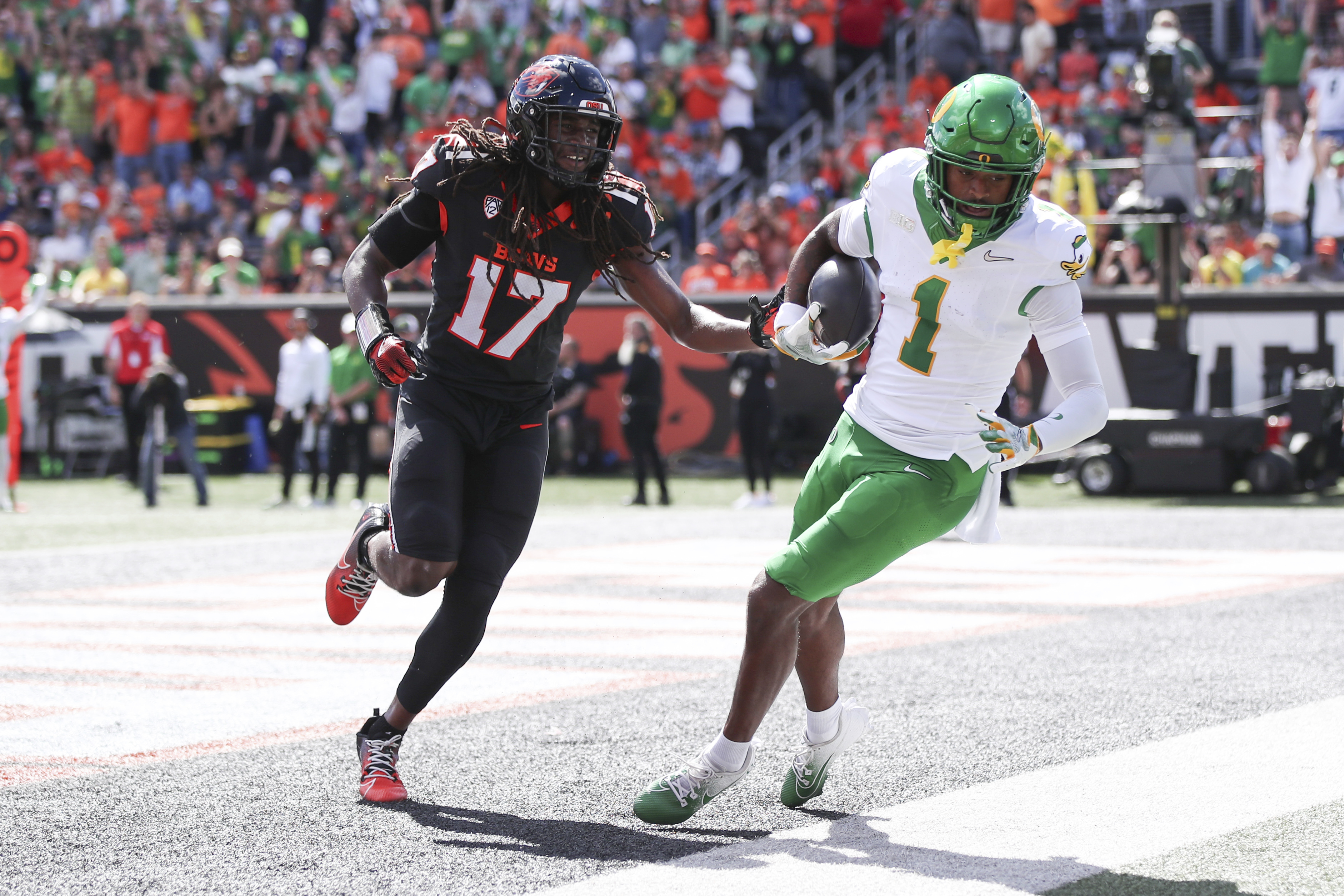Oregon wide receiver Traeshon Holden (1) makes a catch for a touchdown as Oregon State defensive back Skyler Thomas (17) runs after him during the first half of an NCAA football game, Saturday, Sept. 14, 2024, in Corvallis, Ore.