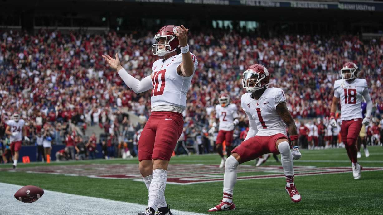 Washington State quarterback John Mateer reacts after running for a touchdown as wide receiver Kris Hutson (1) runs to greet him during the first half of an NCAA college football game against Washington, Saturday, Sept. 14, 2024, in Seattle.