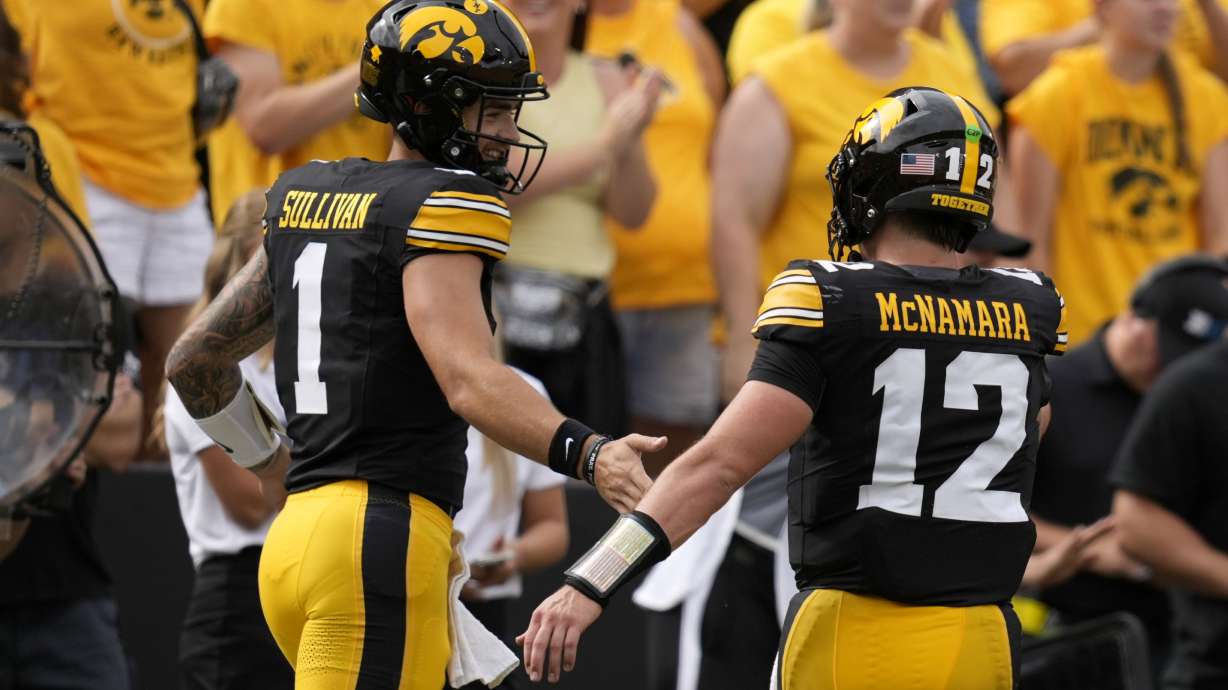 Iowa quarterback Brendan Sullivan (1) celebrates with teammate Cade McNamara (12) after a touchdown during the first half of an NCAA college football game against Troy, Saturday, Sept. 14, 2024, in Iowa City, Iowa.