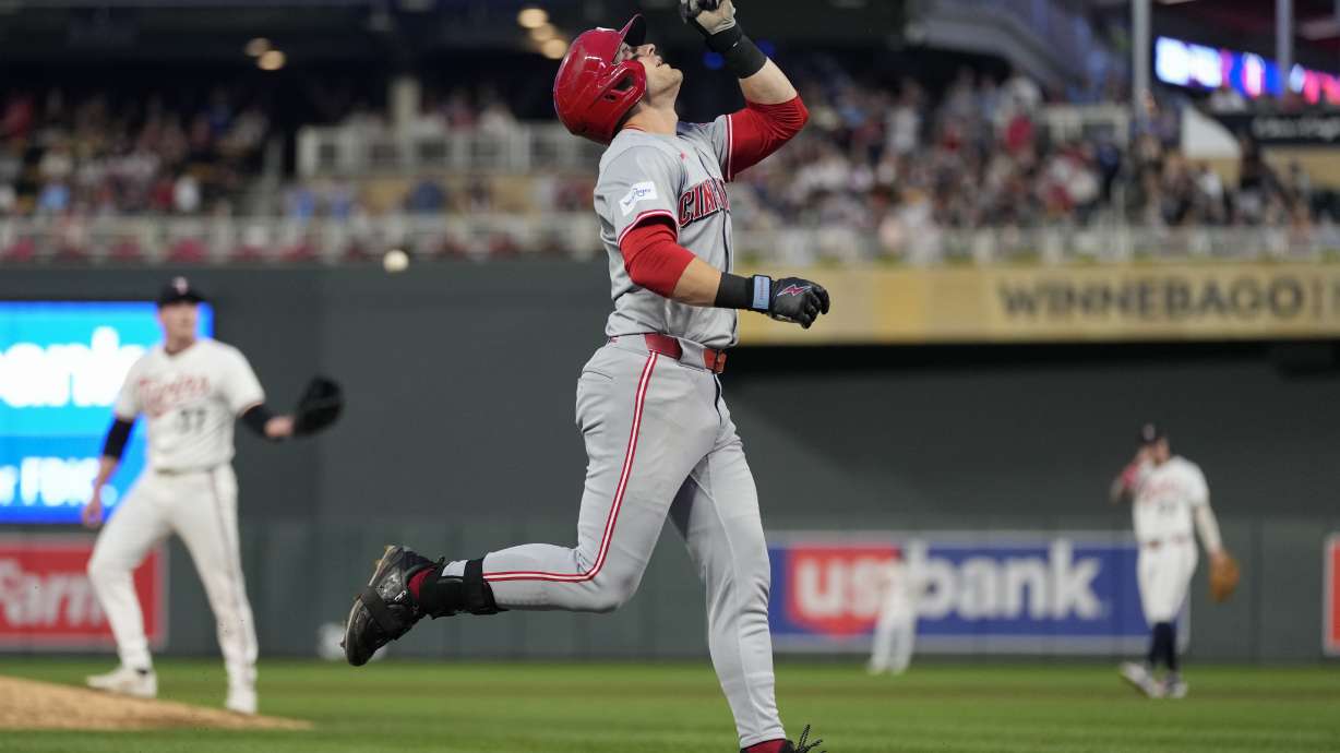 Cincinnati Reds' TJ Friedl points while running the bases after hitting a 2-run home run during the fourth inning of a baseball game against the Minnesota Twins, Saturday, Sept. 14, 2024, in Minneapolis.
