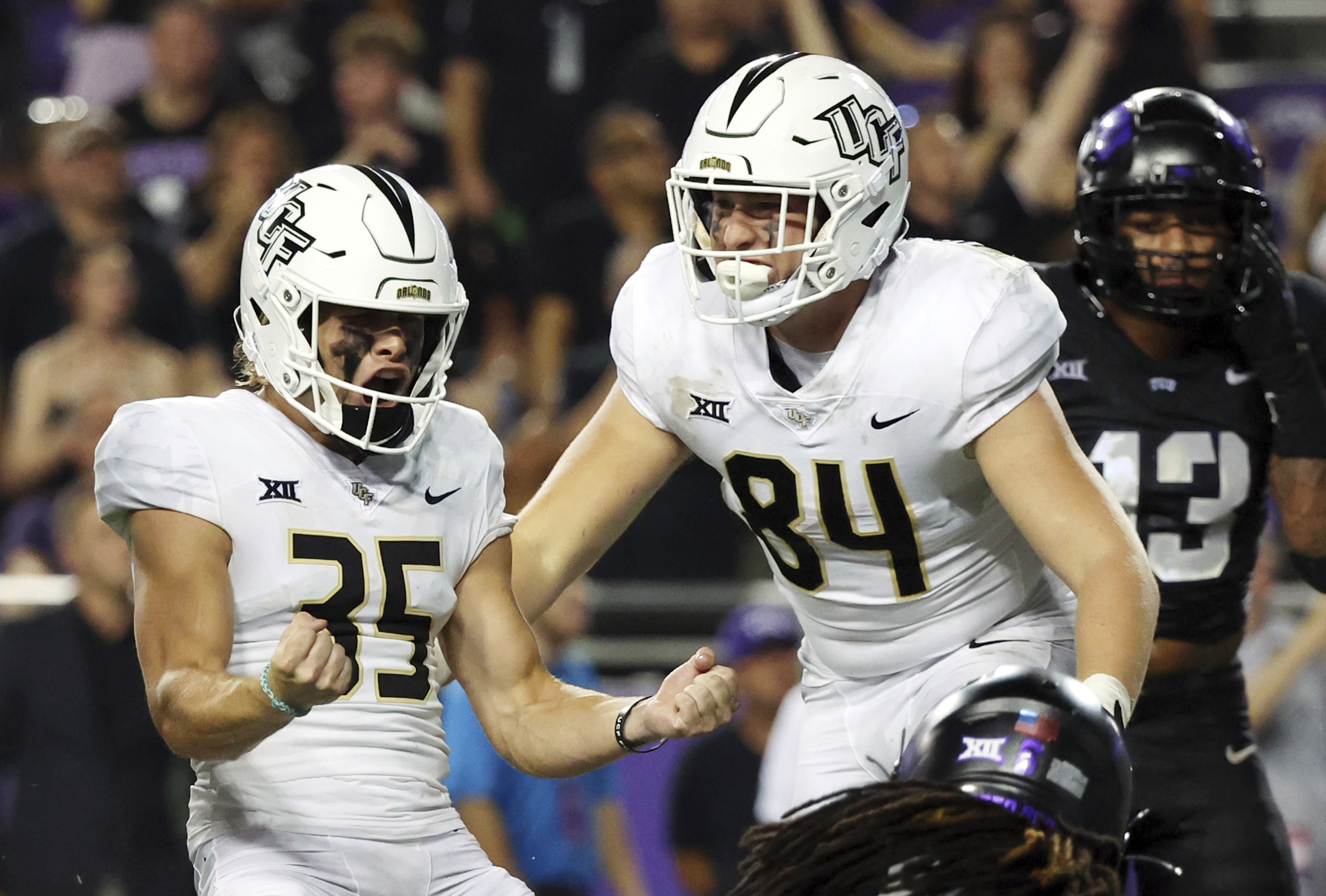 Central Florida place kicker Colton Boomer (35) celebrates with tight end Thomas Wadsworth (84) after kicking an extra point in a win over TCU in an NCAA college football game Saturday, Sept. 14, 2024, in Fort Worth, Texas. 