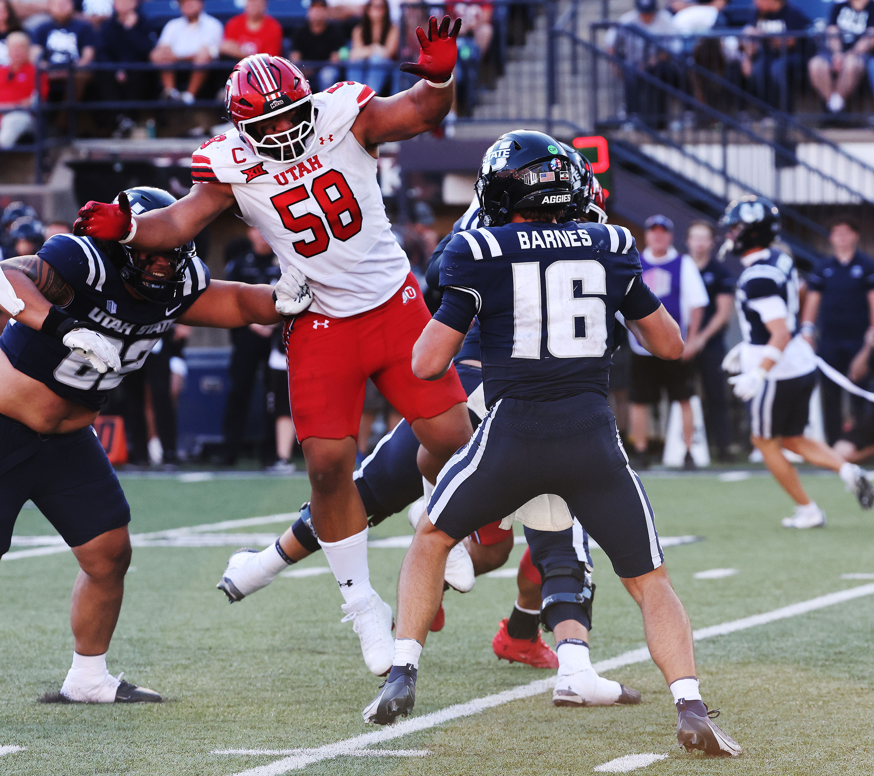Utah Utes defensive tackle Junior Tafuna (58) hurries Utah State Aggies quarterback Bryson Barnes (16) in Logan on Saturday, Sept. 14, 2024.
