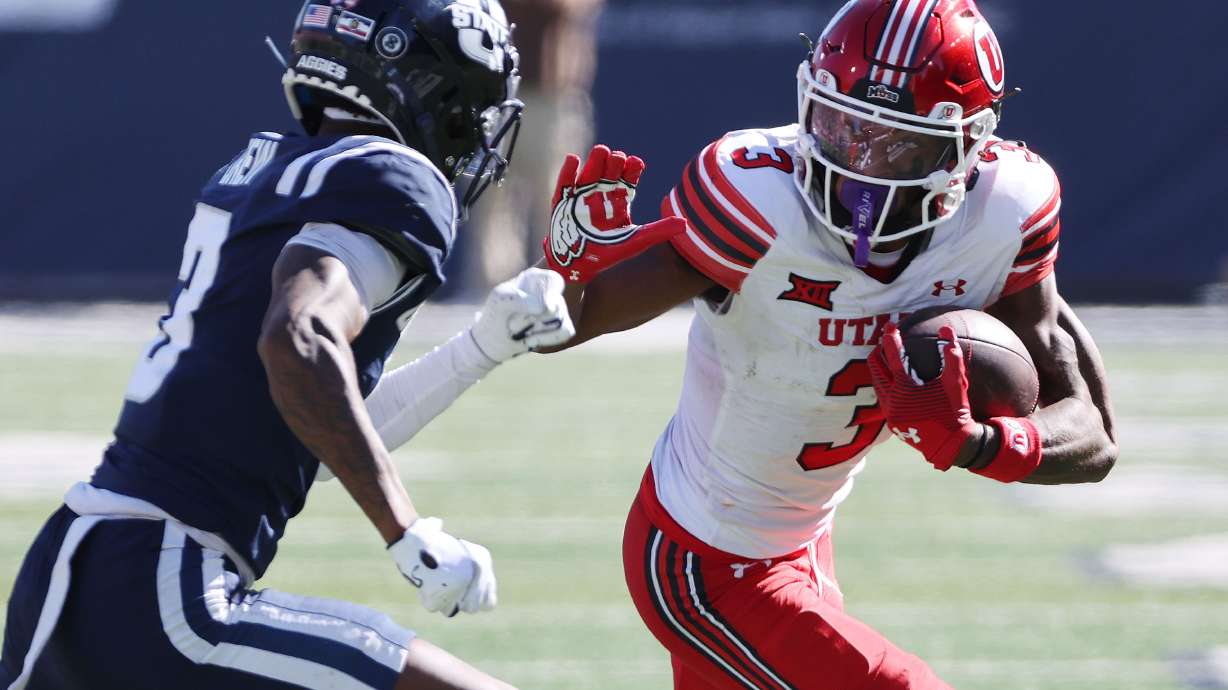 Utah Utes wide receiver Dorian Singer (3) runs agaistn Utah State Aggies cornerback JD Drew (3) in Logan on Saturday, Sept. 14, 2024.