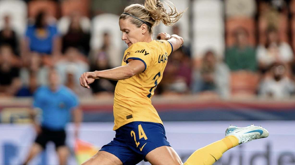 Cloe Lacasse strikes the ball against San Diego.