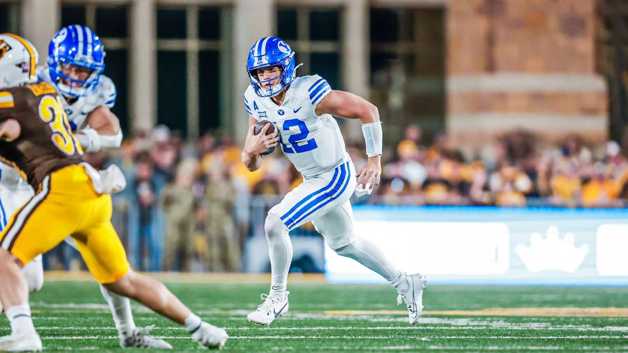 BYU quarterback Jake Retzlaff tucks it and runs during an NCAA football game against Wyoming, Saturday, Sept. 14, 2024 at War Memorial Stadium in Laramie, Wyoming.