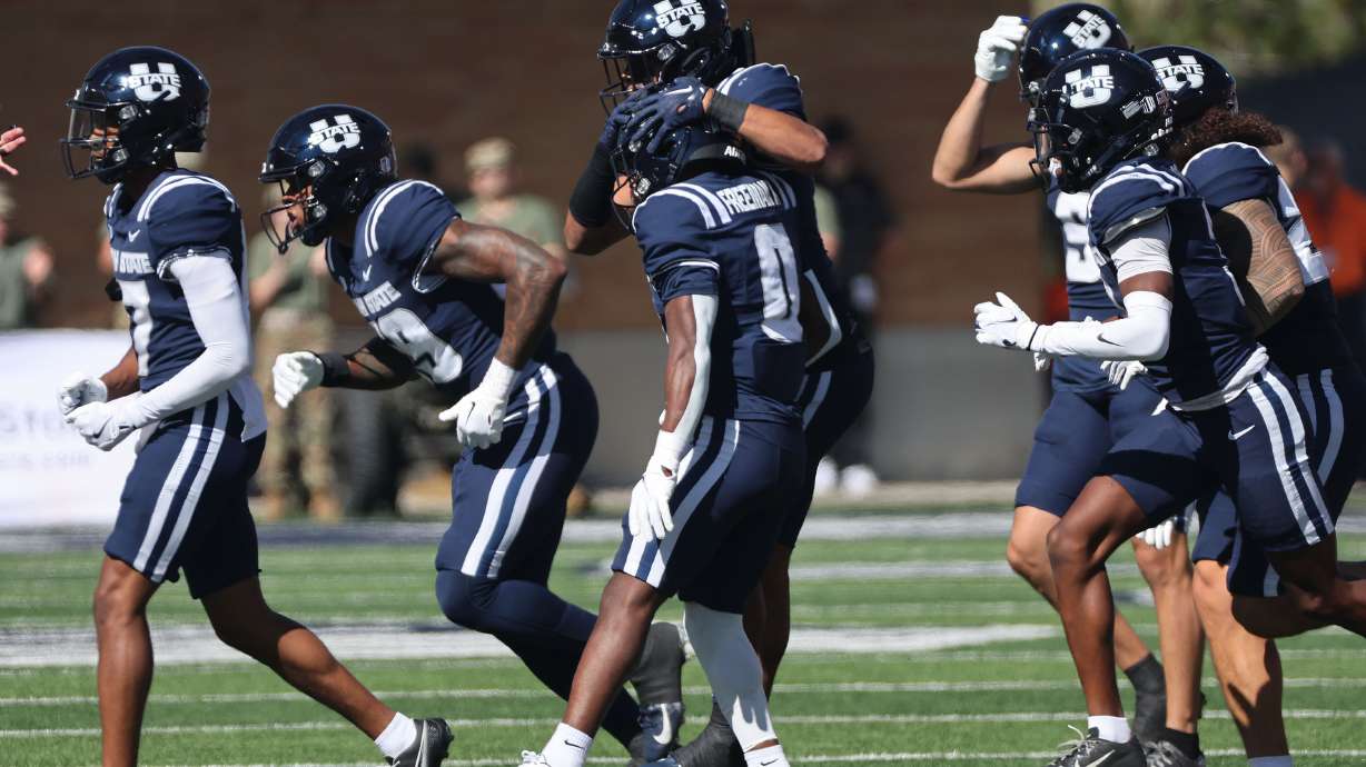 Utah State Aggies wide receiver Robert Freeman IV (0) celebrates a long kick off return against Utah in Logan on Saturday, Sept. 14, 2024.